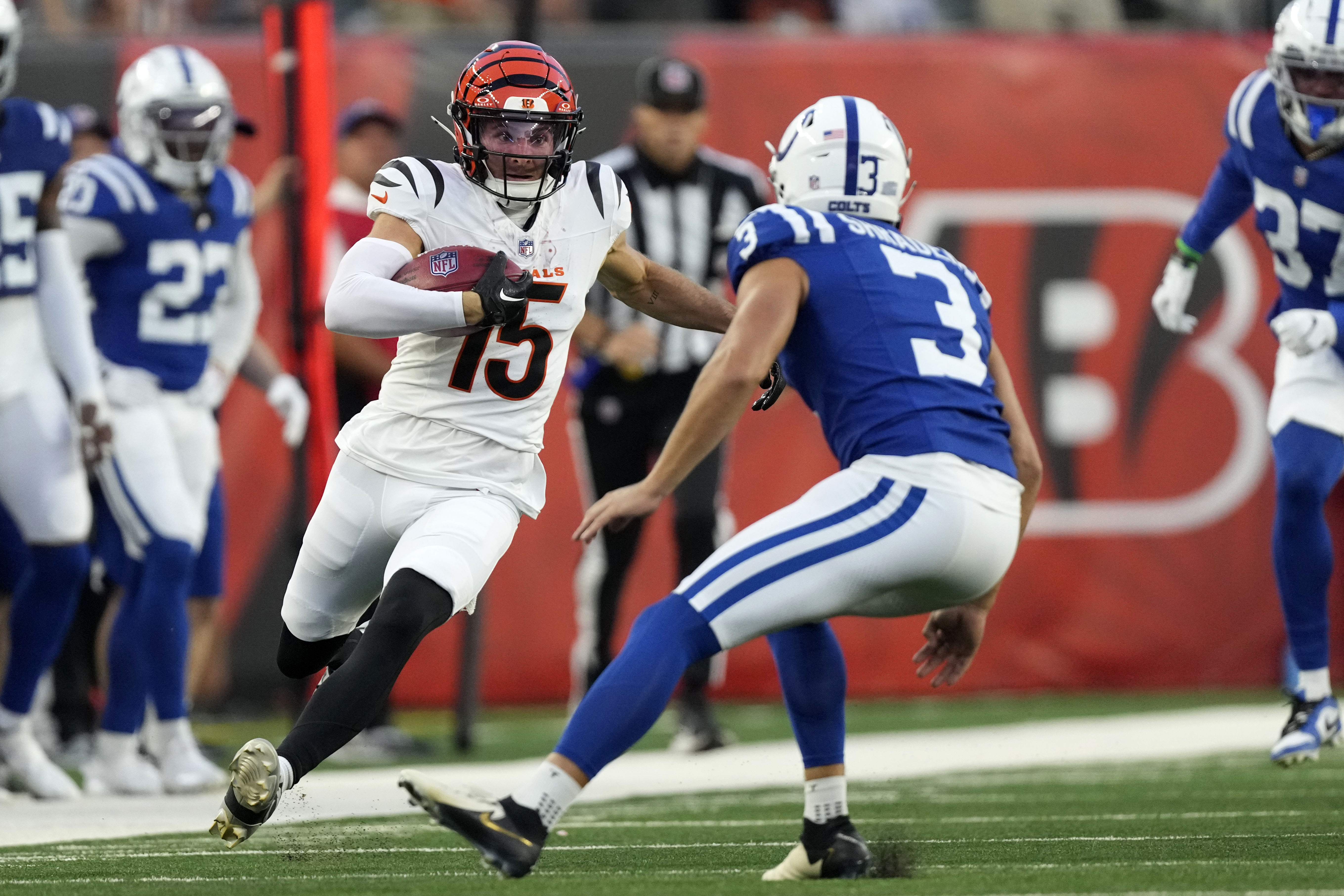 Cincinnati Bengals' Charlie Jones (15) runs from Indianapolis Colts place kicker Spencer Shrader (3) while returning a kickoff during the first half of a preseason NFL football game, Thursday, Aug. 22, 2024, in Cincinnati. 