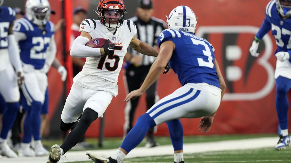 Cincinnati Bengals' Charlie Jones (15) runs from Indianapolis Colts place kicker Spencer Shrader (3) while returning a kickoff during the first half of a preseason NFL football game, Thursday, Aug. 22, 2024, in Cincinnati.