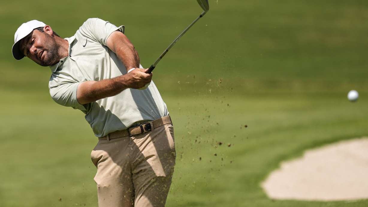 Scottie Scheffler hits from the first fairway during the final round of the Tour Championship golf tournament, Sunday, Sept. 1, 2024, in Atlanta.