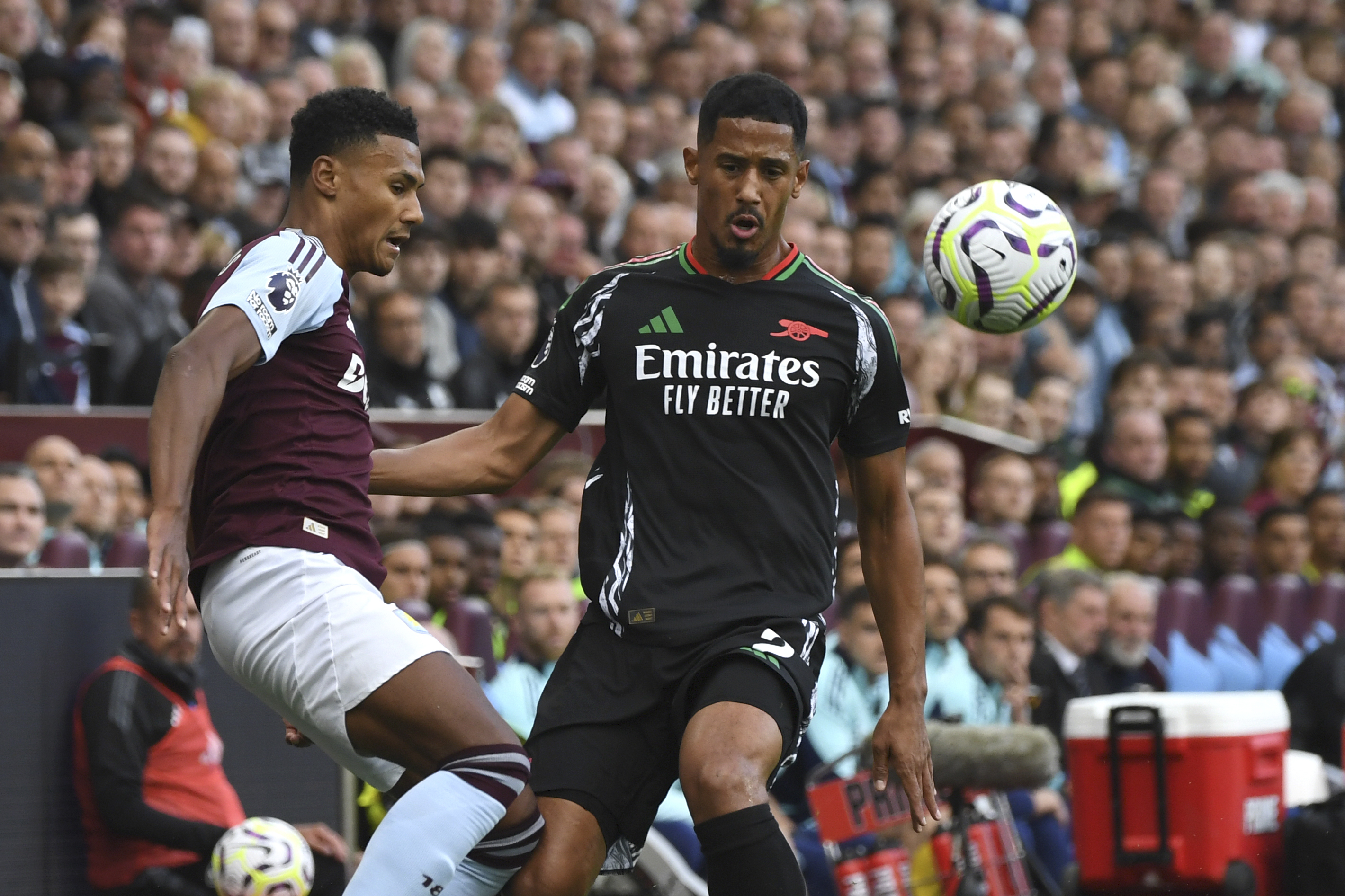 Aston Villa's Ollie Watkins, left, challenges for the ball with Arsenal's William Saliba during the English Premier League soccer match between Aston Villa and Arsenal at Villa Park in Birmingham, England, Saturday, Aug. 24, 2024. 