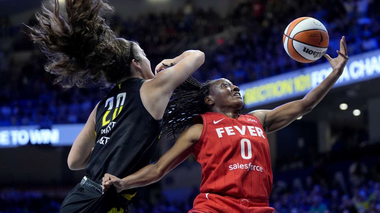 Indiana Fever guard Kelsey Mitchell (0) is blocked on a shot by Dallas Wings' Maddy Siegrist (20) in the first half of a WNBA basketball game Sunday, Sept. 1, 2024, in Arlington, Texas.