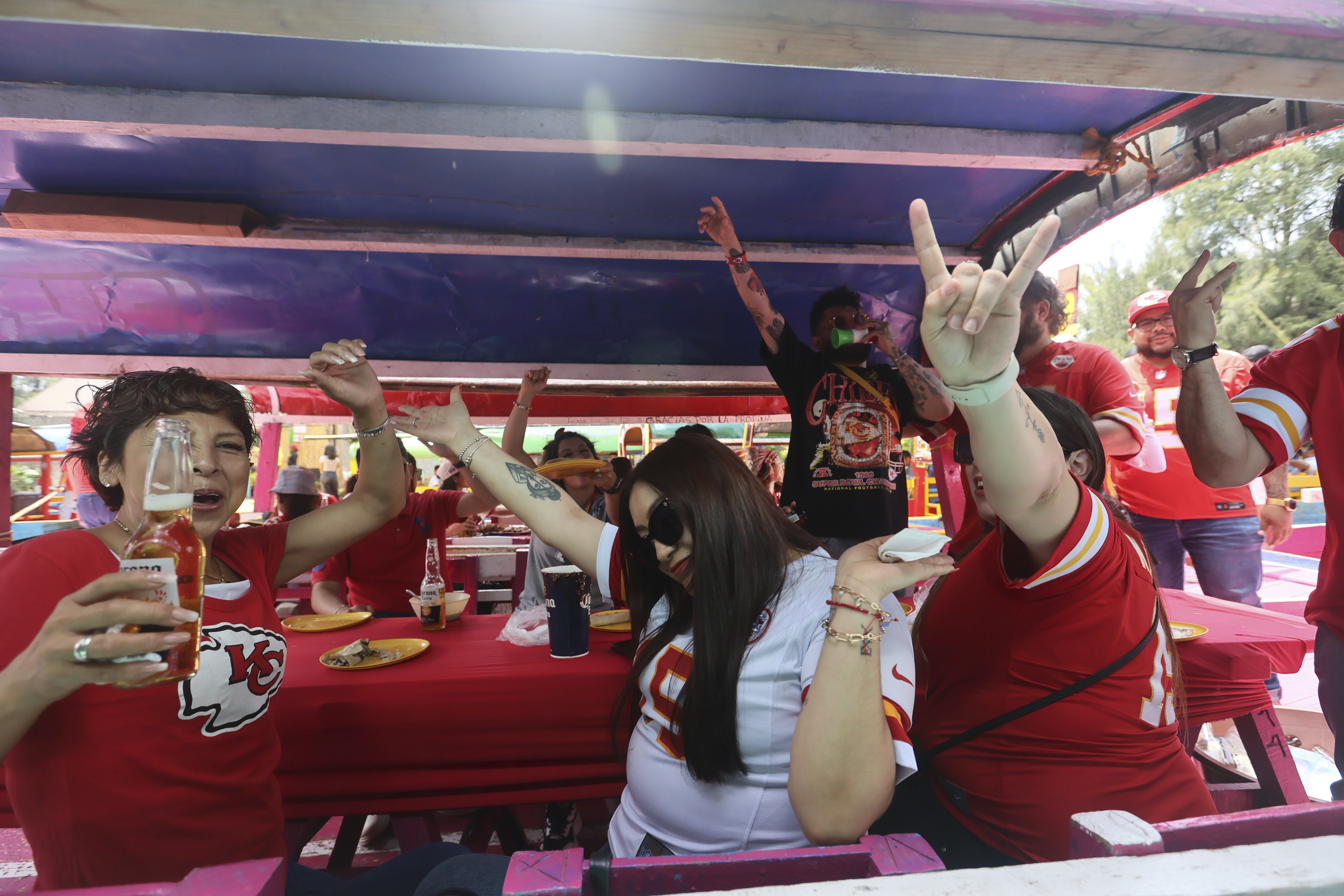 Kansas City Chiefs fans ride on "trajinera" boats along the water canals of Xochimilco in Mexico City, Sunday, Sept. 1, 2024, as they celebrate the arrival of a new NFL season. 