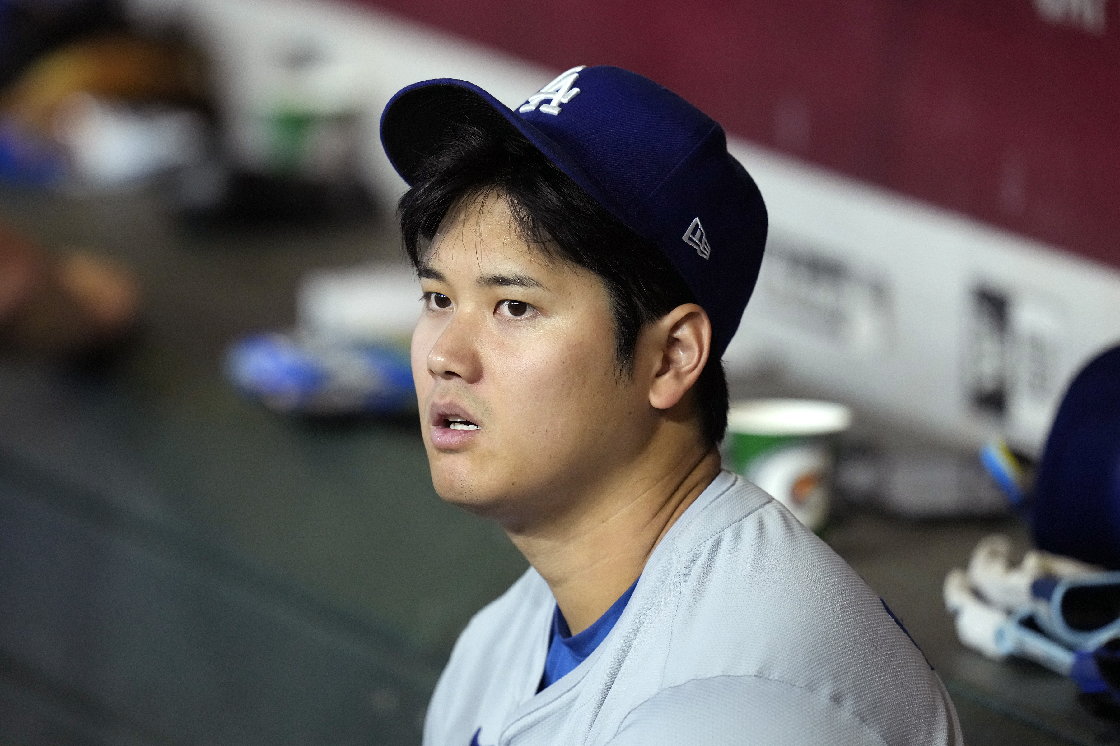 Los Angeles Dodgers' Shohei Ohtani, of Japan, sits in the dugout during the seventh inning of a baseball game against the Arizona Diamondbacks, Sunday, Sept. 1, 2024, in Phoenix.