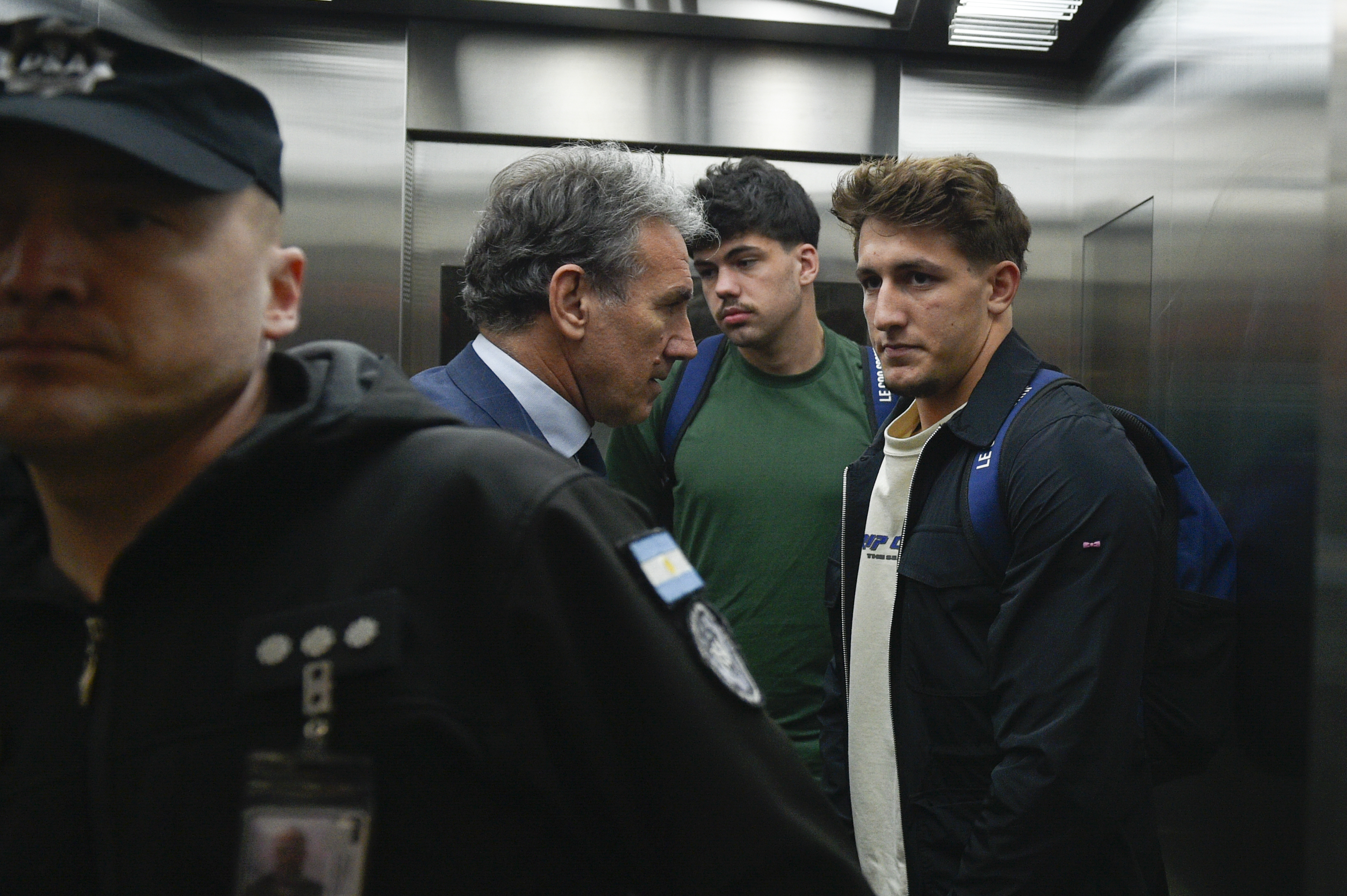 French rugby players Oscar Jegou, right, and Hugo Auradou, second from right, stand next to their lawyer Rafael Cuneo Libarona at the airport in Buenos Aires, Argentina, Tuesday, Sept. 3, 2024. Argentine prosecutors decided to let Auradou and Jegou leave the country despite the players remaining under investigation for alleged rape.