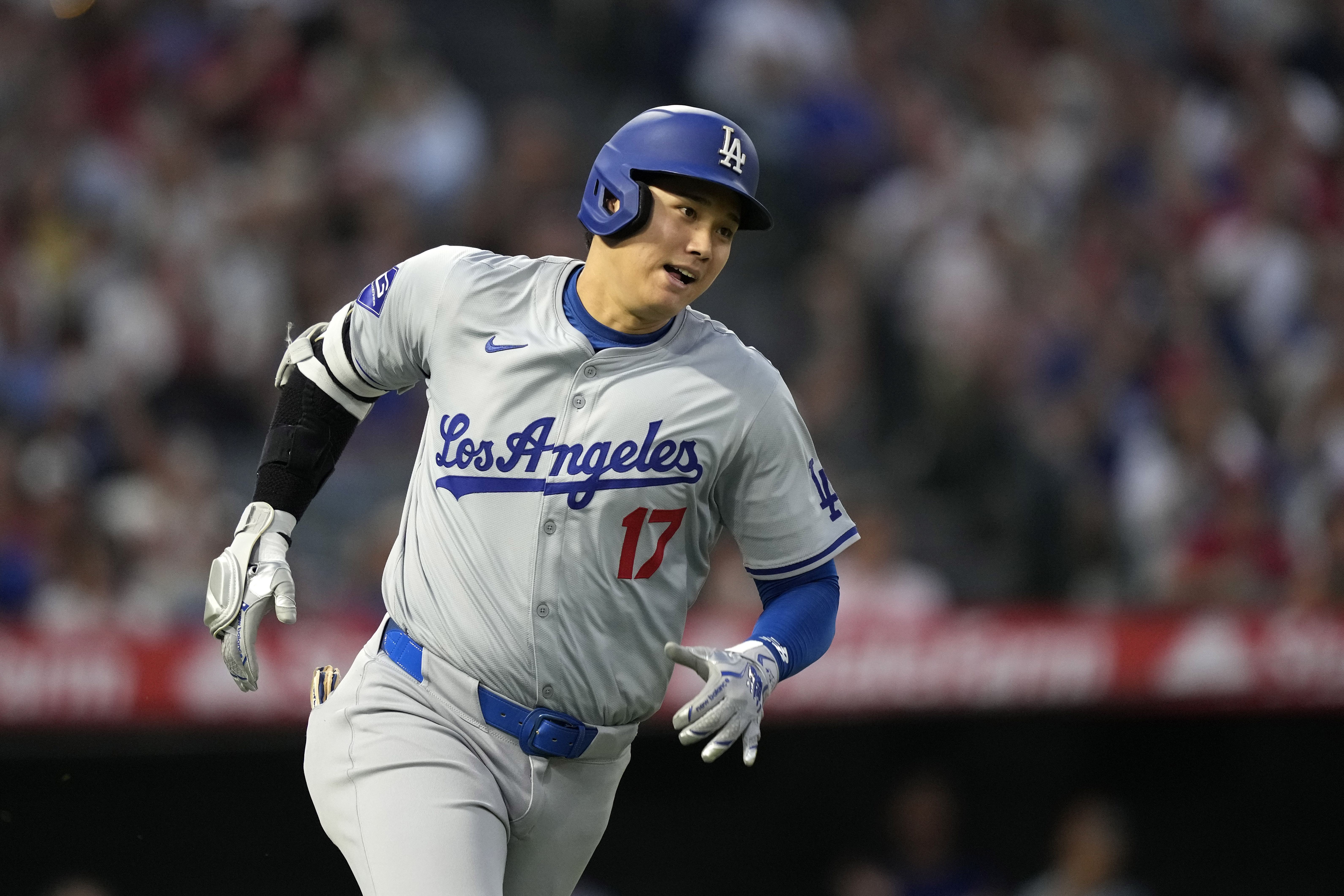 Los Angeles Dodgers' Shohei Ohtani heads to first for an RBI triple during the third inning of a baseball game against the Los Angeles Angels, Tuesday, Sept. 3, 2024, in Anaheim, Calif. 