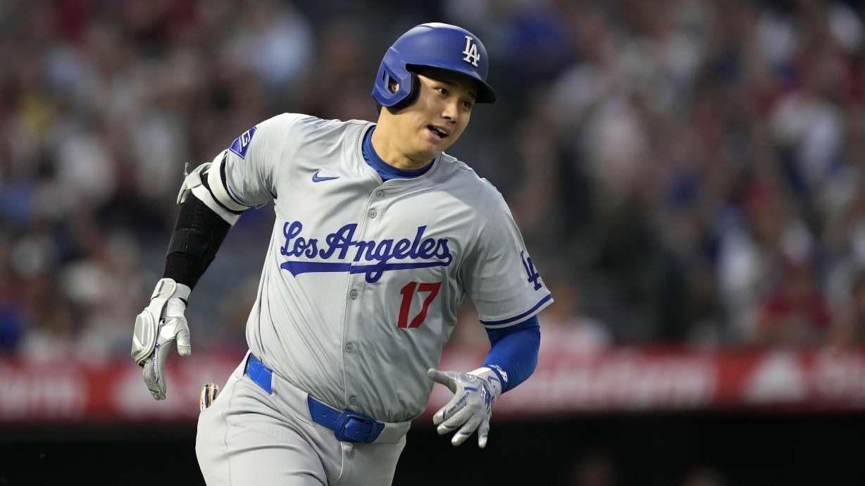 Los Angeles Dodgers' Shohei Ohtani heads to first for an RBI triple during the third inning of a baseball game against the Los Angeles Angels, Tuesday, Sept. 3, 2024, in Anaheim, Calif.