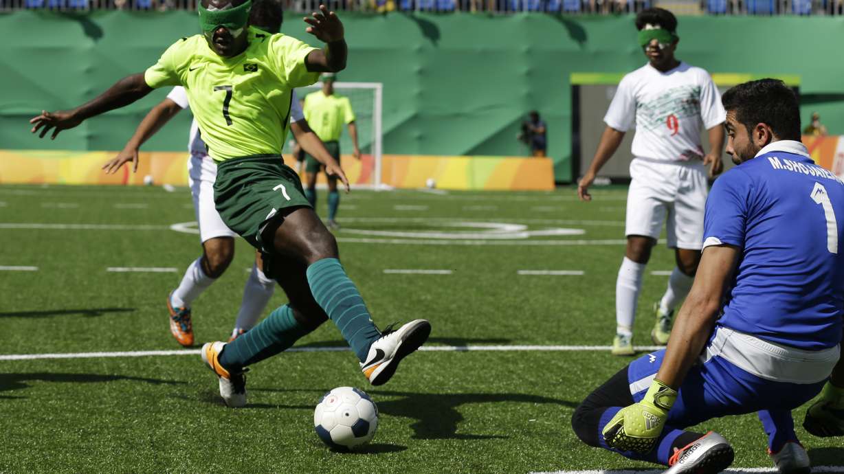 FILE - Brazil's Jefinho, left, kicks the ball as Iran' goalkeeper Meysam Shojaeiyan blocks, during a men's group A preliminary soccer 5-a-side match, at the Paralympic Games event in Rio de Janeiro, Brazil, Tuesday, Sept. 13, 2016.