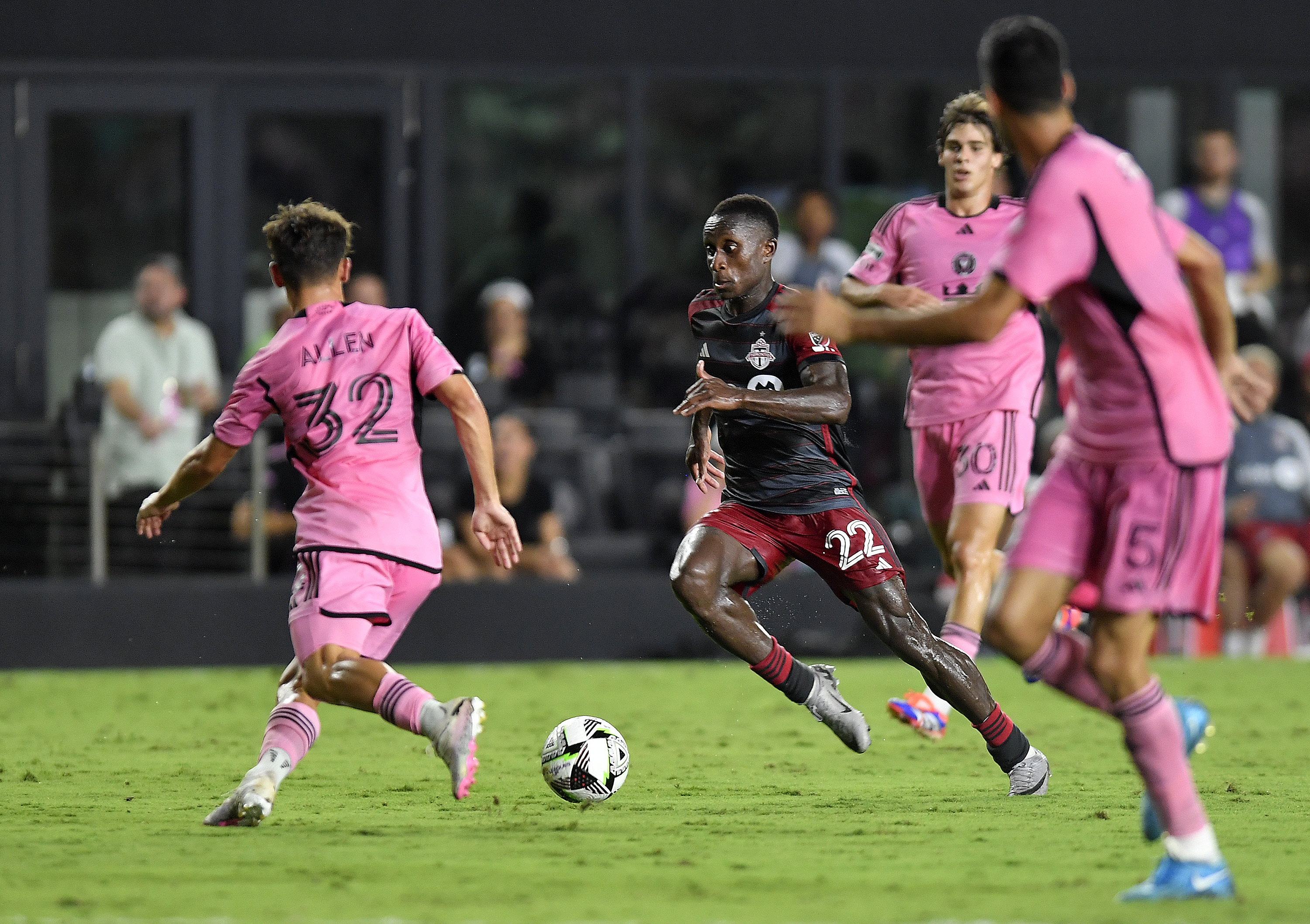 Toronto FC midfielder Richie Laryea (22) dribbles through the Inter Miami defense during the second half of a Leagues Cup soccer game Thursday, Aug. 8, 2024, in Fort Lauderdale, Fla. 