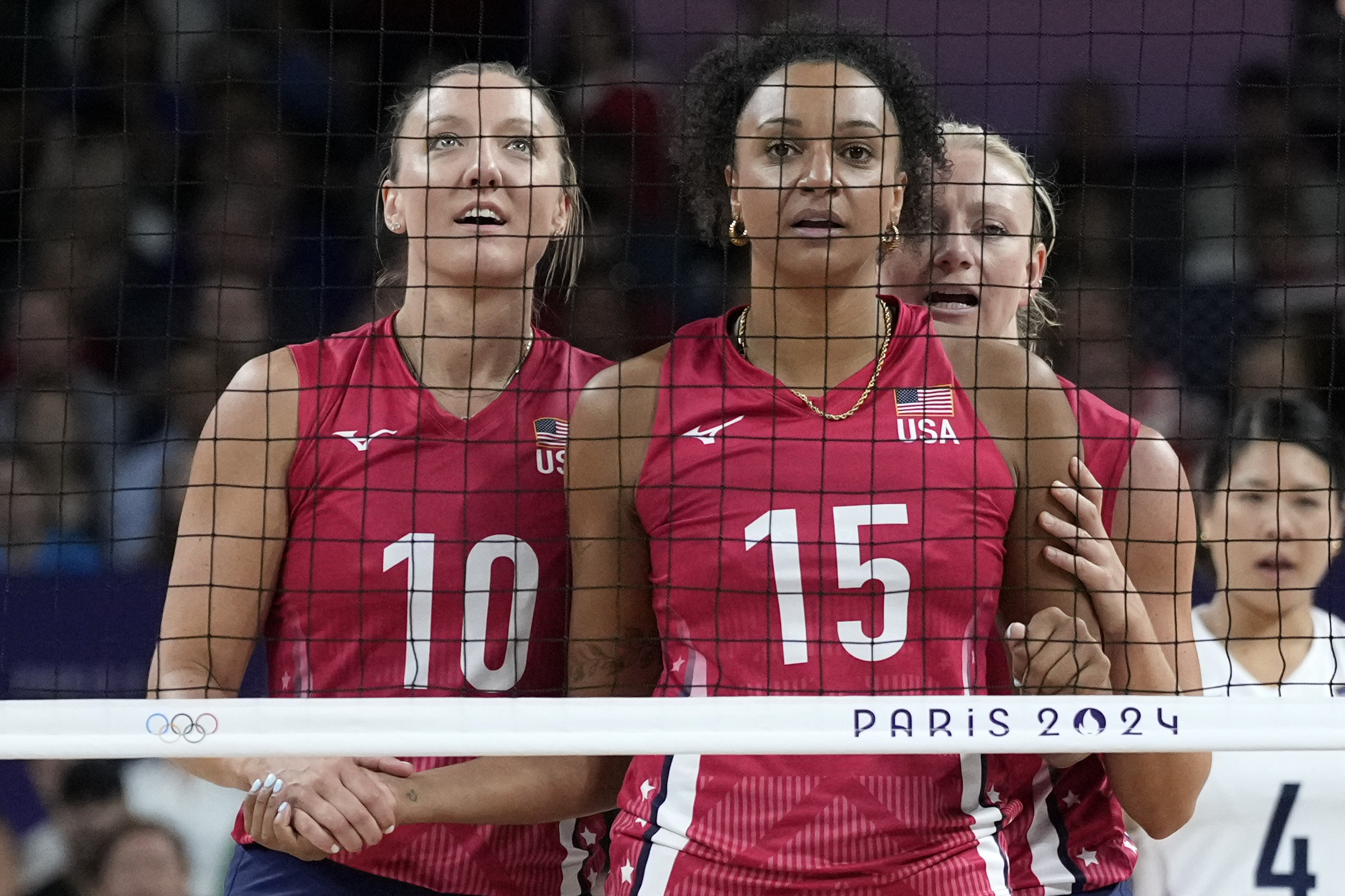 Jordan Larson of the United States, and Haleigh Washington of the United States, reacts behind the net during a gold medal women's volleyball match between the United States of America and Italy at the 2024 Summer Olympics, Sunday, Aug. 11, 2024, in Paris, France.