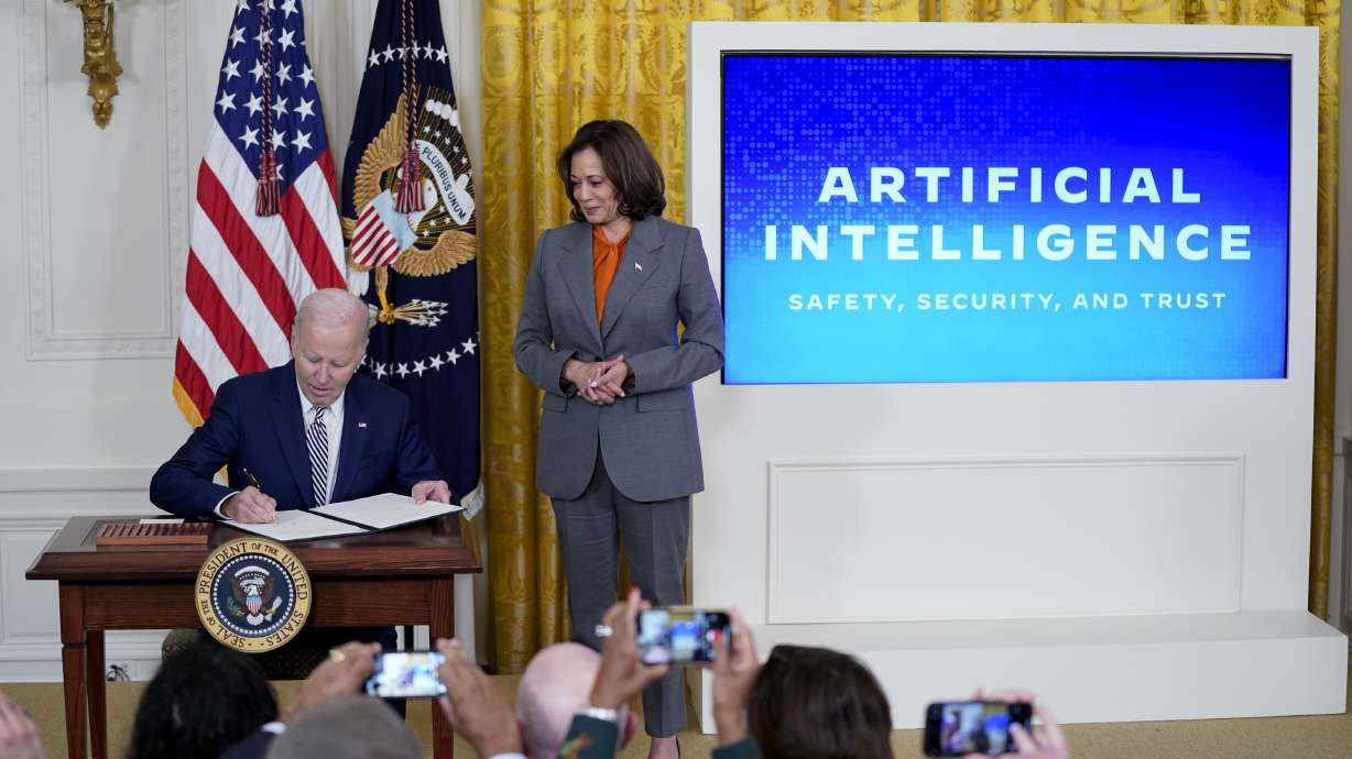 President Joe Biden signs an executive order on artificial intelligence in the East Room of the White House, Oct. 30, 2023, in Washington. Vice President Kamala Harris looks on. The order placed operational limits on AI.
