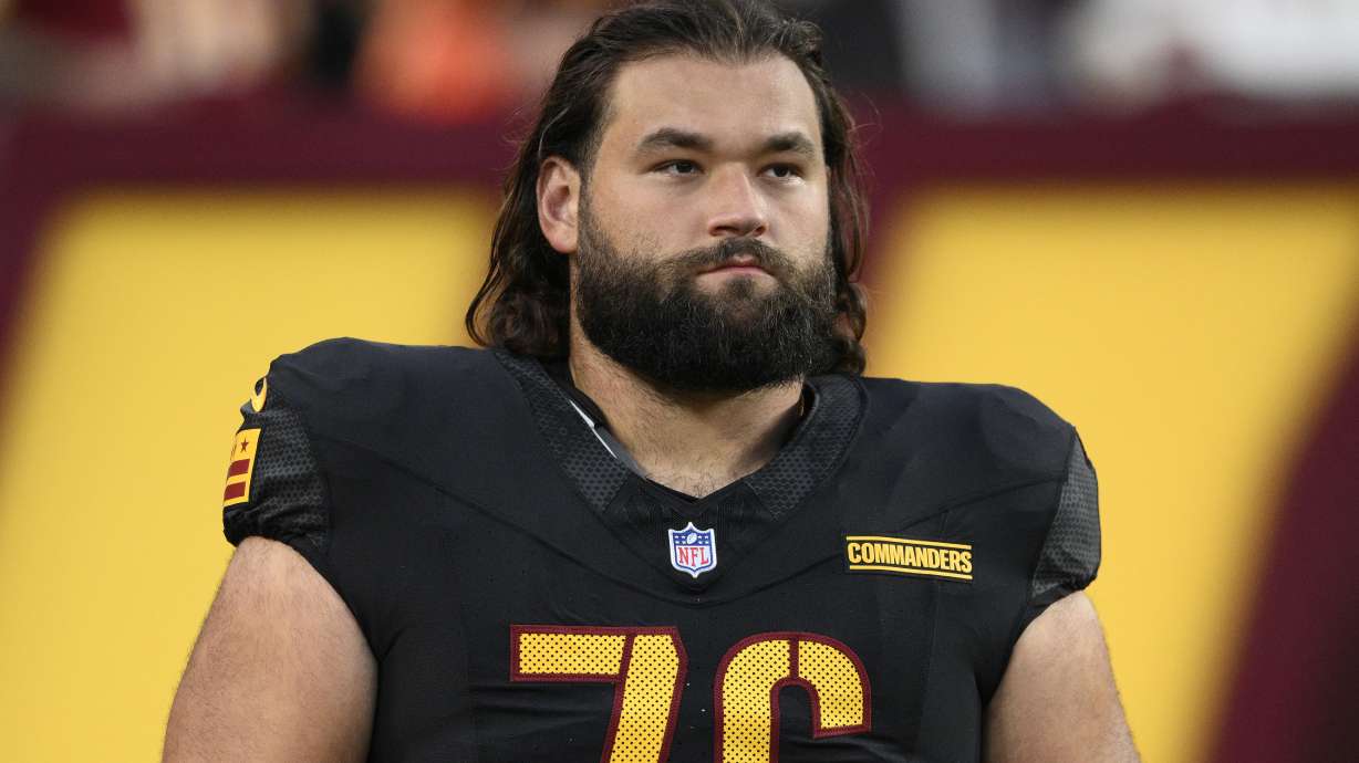 FILE - Washington Commanders guard Sam Cosmi (76) looks on before an NFL preseason football game against the New England Patriots, Aug. 25, 2024, in Landover, Md.