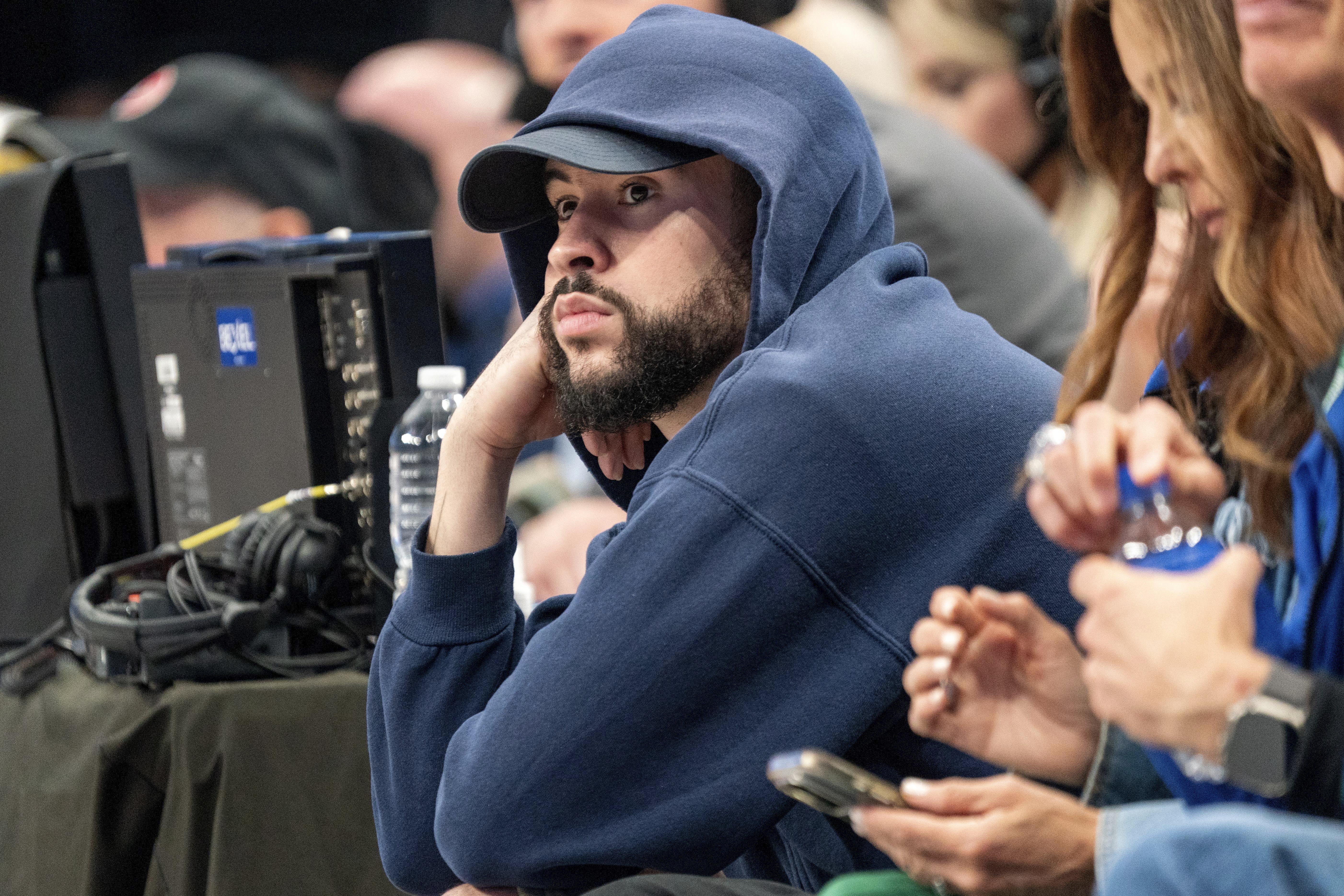 FILE - Puerto Rican recording artist Bad Bunny sits courtside during game 6 of an NBA basketball first-round playoff series between the Dallas Mavericks and the Los Angeles Clippers Friday, May 3, 2024, in Dallas. A federal judge halted a lawsuit by Bad Bunny’s sports representation firm against the Major League Baseball Players Association, ruling Thursday, AUg. 15, 2024, the case should be heard by an arbitrator. 