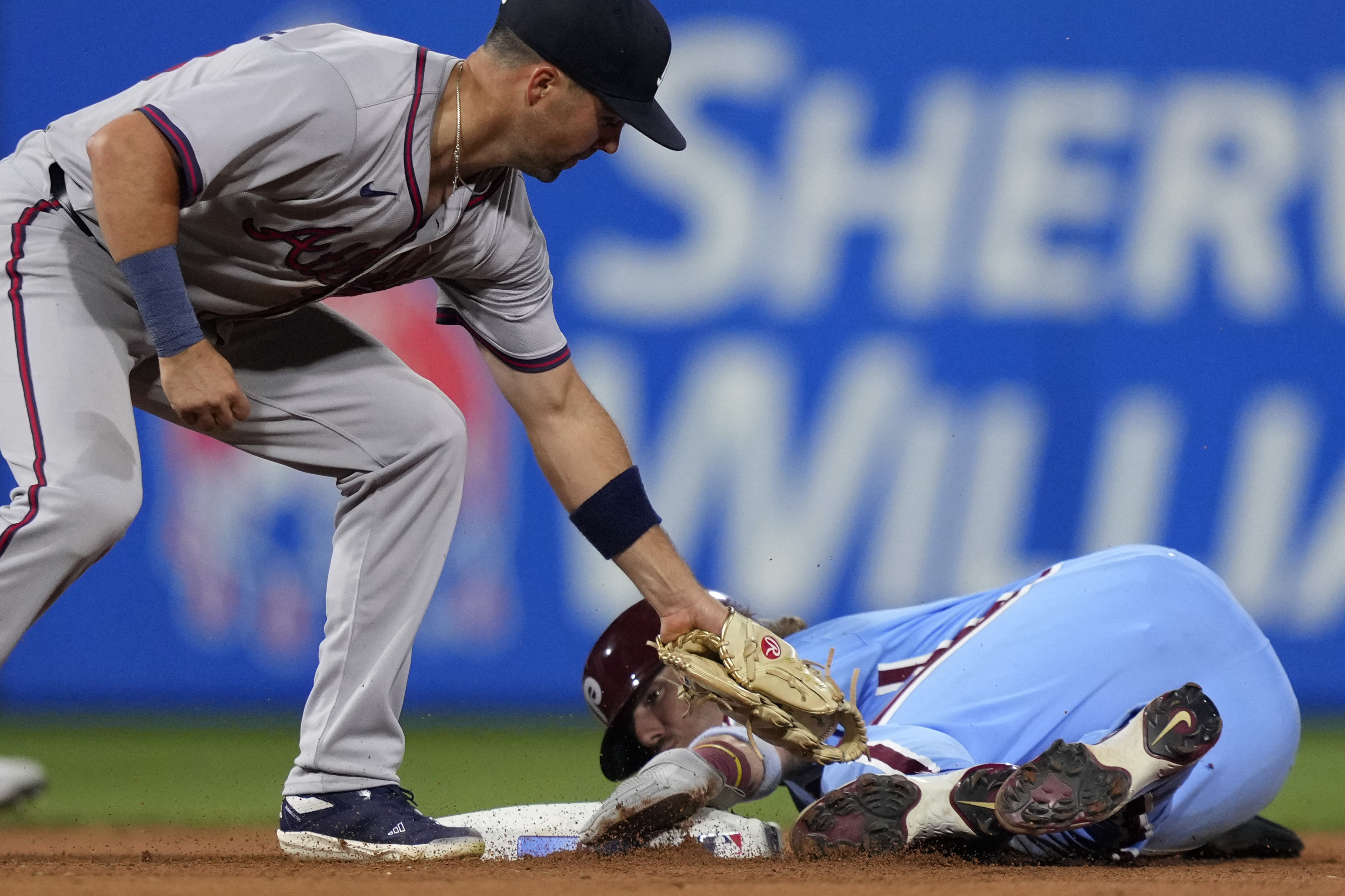 Philadelphia Phillies' Bryson Stott, right, steals second past Atlanta Braves second baseman Whit Merrifield during the fourth inning of a baseball game, Thursday, Aug. 29, 2024, in Philadelphia. 