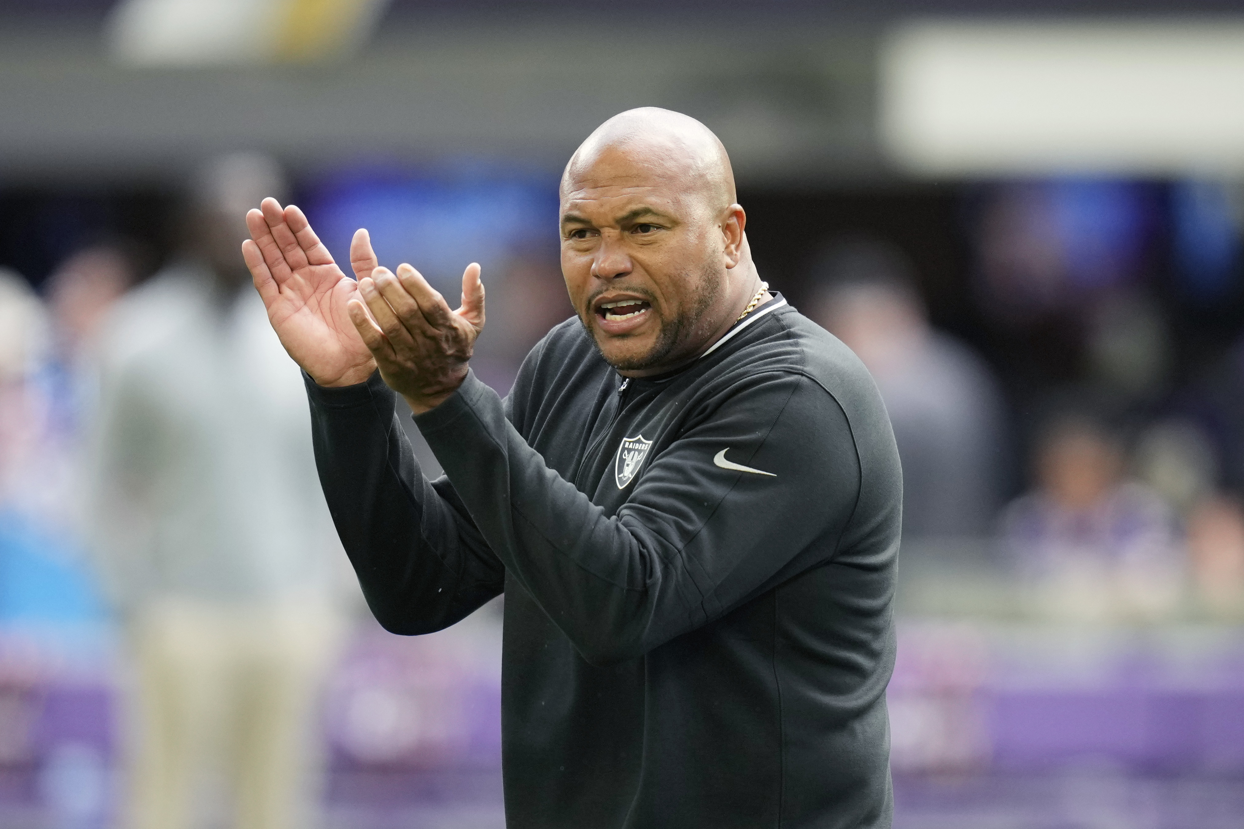 Las Vegas Raiders head coach Antonio Pierce talks to his players before an NFL preseason football game against the Minnesota Vikings, Saturday, Aug. 10, 2024, in Minneapolis. 