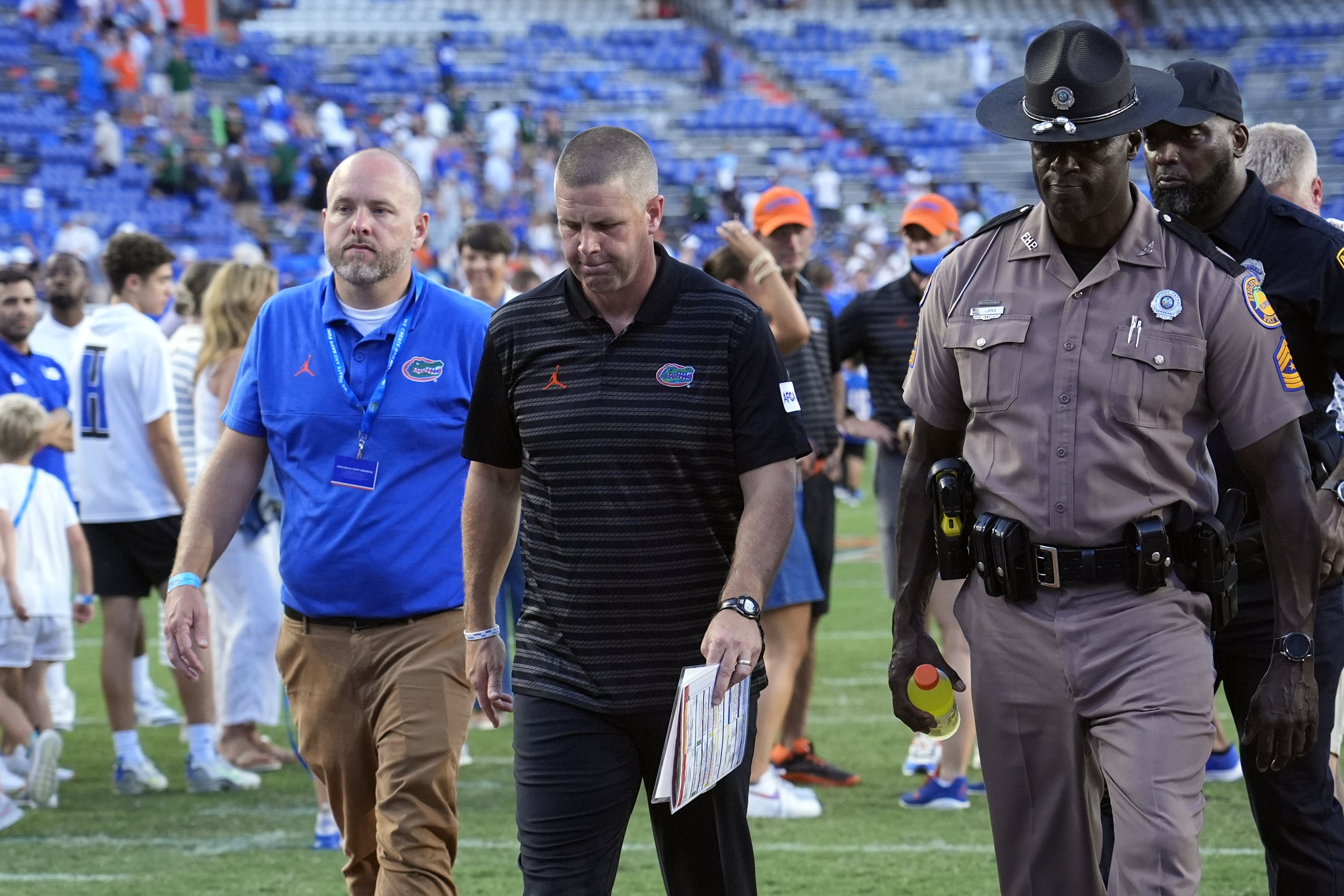Florida head coach Billy Napier, center, walks off the field after his team was defeated by Miami, 41-17, in an NCAA college football game, Saturday, Aug. 31, 2024, in Gainesville, Fla. 