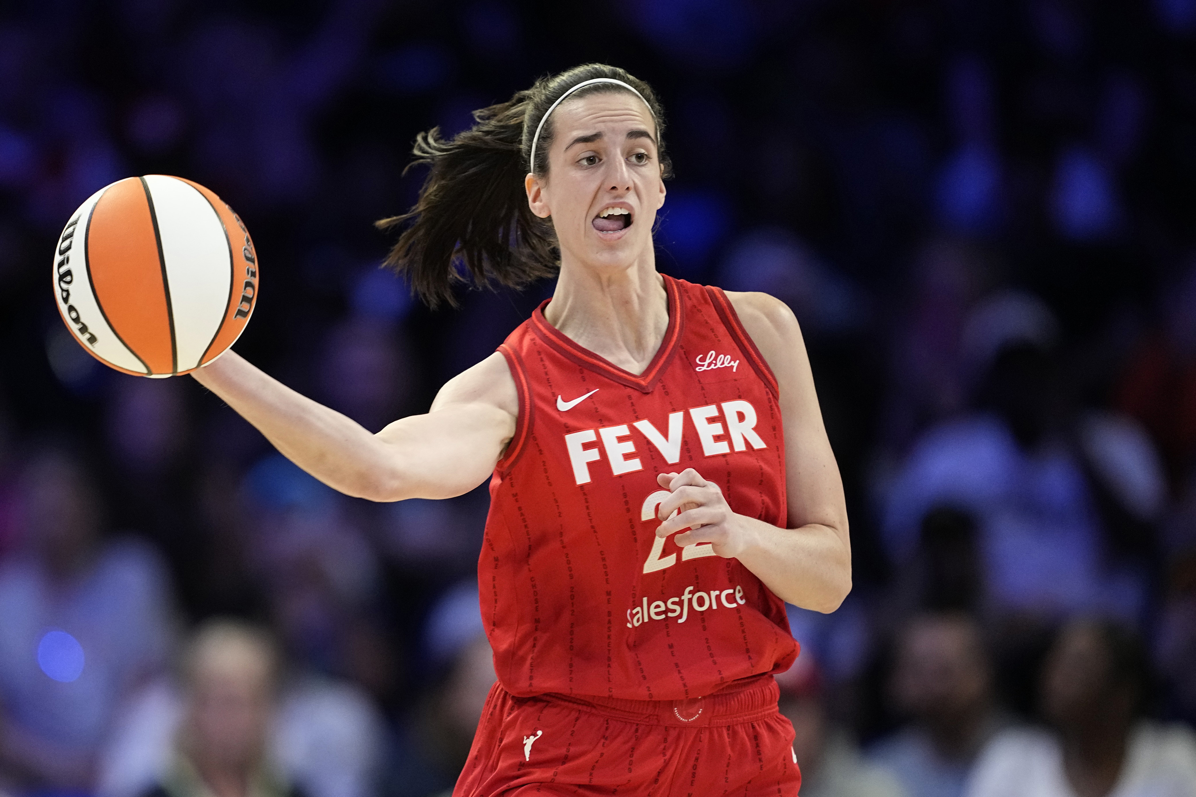 Indiana Fever's Caitlin Clark makes a long pass upcourt in the first half of a WNBA basketball game against the Dallas Wings, Sunday, Sept. 1, 2024, in Arlington, Texas.