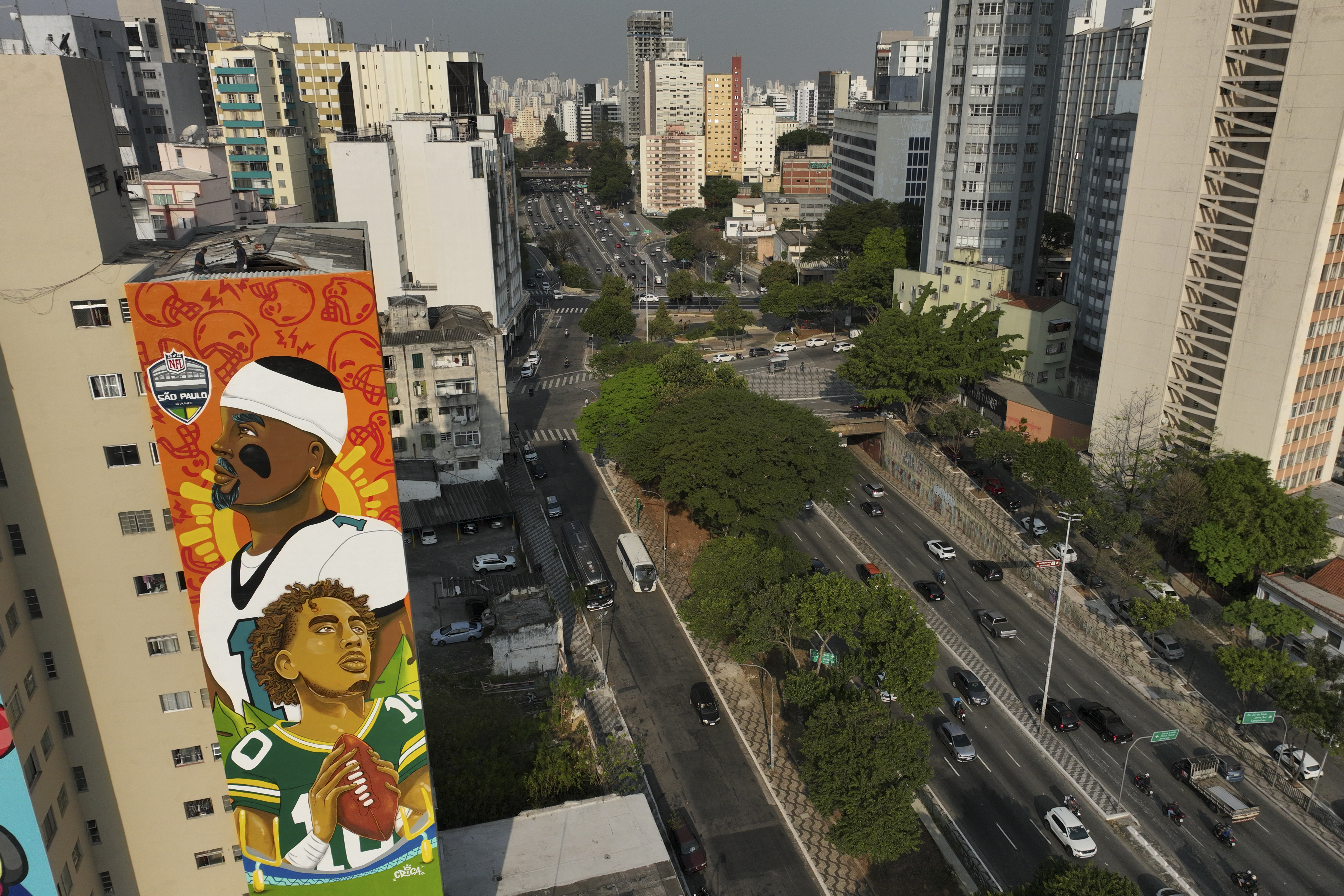 A mural created by artist Crica featuring Philadelphia Eagles quarterback Jalen Hurts and Green Bay Packers quarterback Jordan Love adorns an apartment building in downtown Sao Paulo, Wednesday, Sept. 4, 2024. 