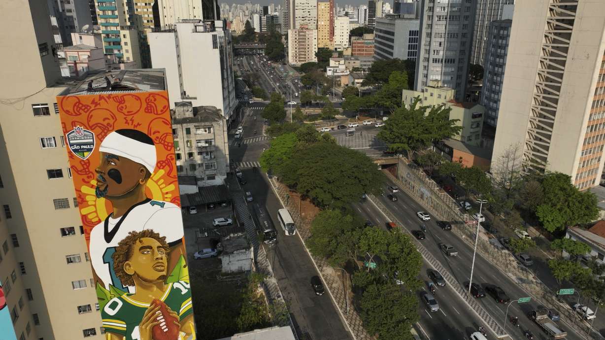 A mural created by artist Crica featuring Philadelphia Eagles quarterback Jalen Hurts and Green Bay Packers quarterback Jordan Love adorns an apartment building in downtown Sao Paulo, Wednesday, Sept. 4, 2024.