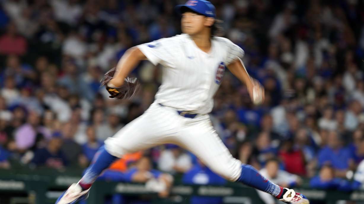 In this image taken with a slow shutter speed, Chicago Cubs pitcher Shota Imanaga throws during the fifth inning of a baseball game against the Pittsburgh Pirates on Wednesday, Sept. 4, 2024, in Chicago.