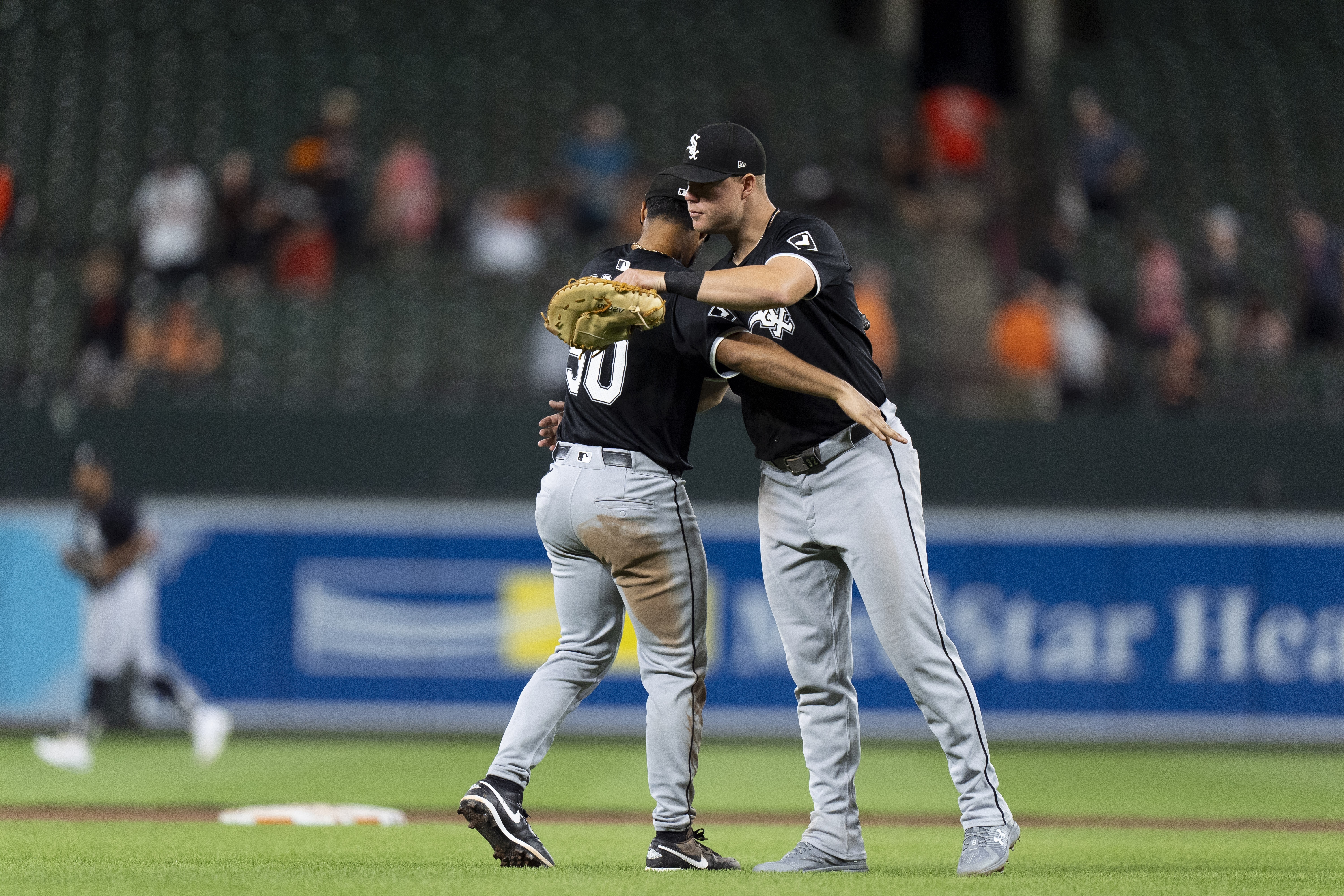 Chicago White Sox third baseman Lenyn Sosa, left, and relief pitcher Justin Anderson, right, celebrate their team's win over the Baltimore Orioles after a baseball game, Wednesday, Sept. 4, 2024, in Baltimore. 