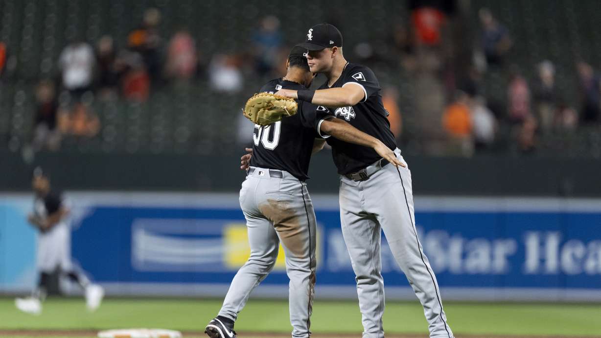 Chicago White Sox third baseman Lenyn Sosa, left, and relief pitcher Justin Anderson, right, celebrate their team's win over the Baltimore Orioles after a baseball game, Wednesday, Sept. 4, 2024, in Baltimore.
