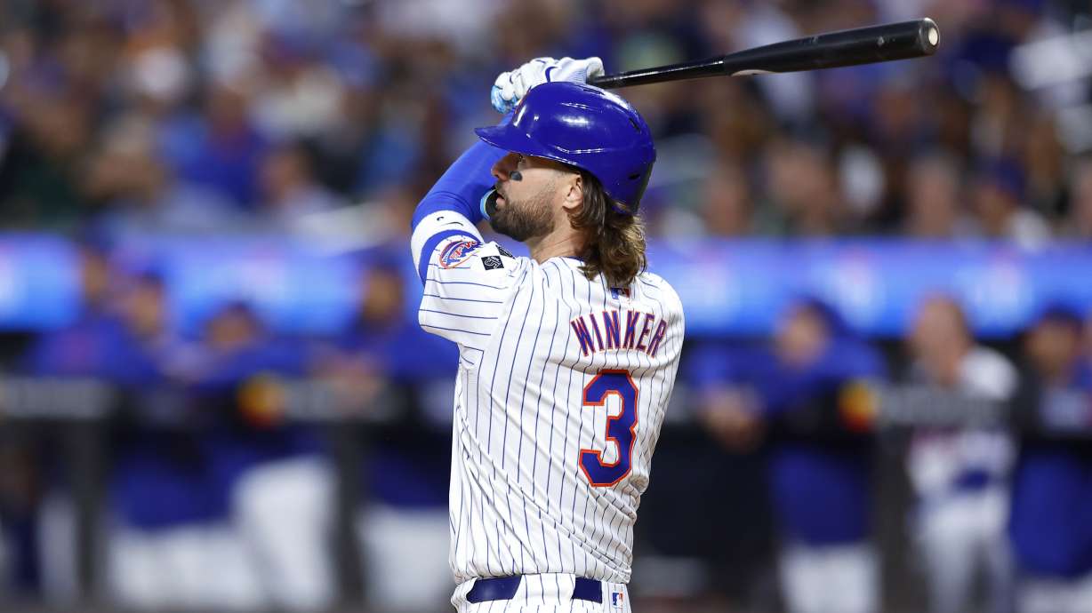 New York Mets' Jesse Winker follows through on a grand slam against the Boston Red Sox during the first inning of a baseball game, Wednesday, Sept. 4, 2024, in New York.