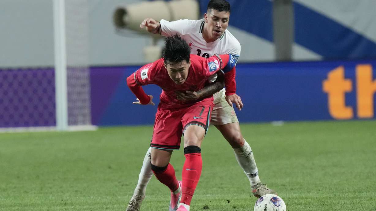 South Korea's Son Heung-min, bottom, fights for the ball with Jonathan Zorrilla during the Asian qualifier group B match for 2026 World Cup between South Korea and Palestine at the World Cup Stadium in Seoul, South Korea, Thursday, Sept. 5, 2024.