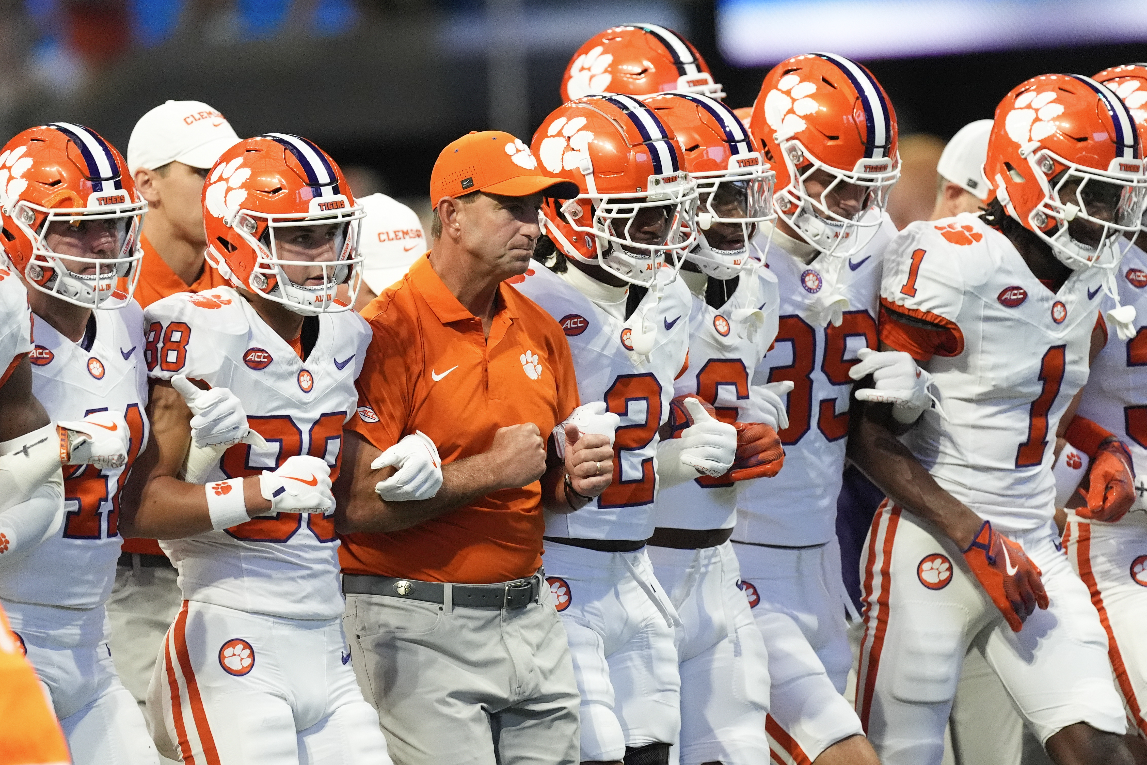 Clemson head coach Dabo Swinney, center, walks with his players before an NCAA college football game againt Georgia Aug. 31, 2024, in Atlanta. 