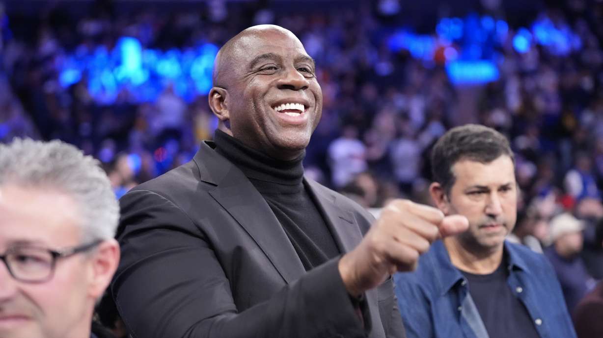 FILE - Magic Johnson waves to people before an NBA basketball game between the New York Knicks and the Los Angeles Lakers Saturday, Feb. 3, 2024, in New York.
