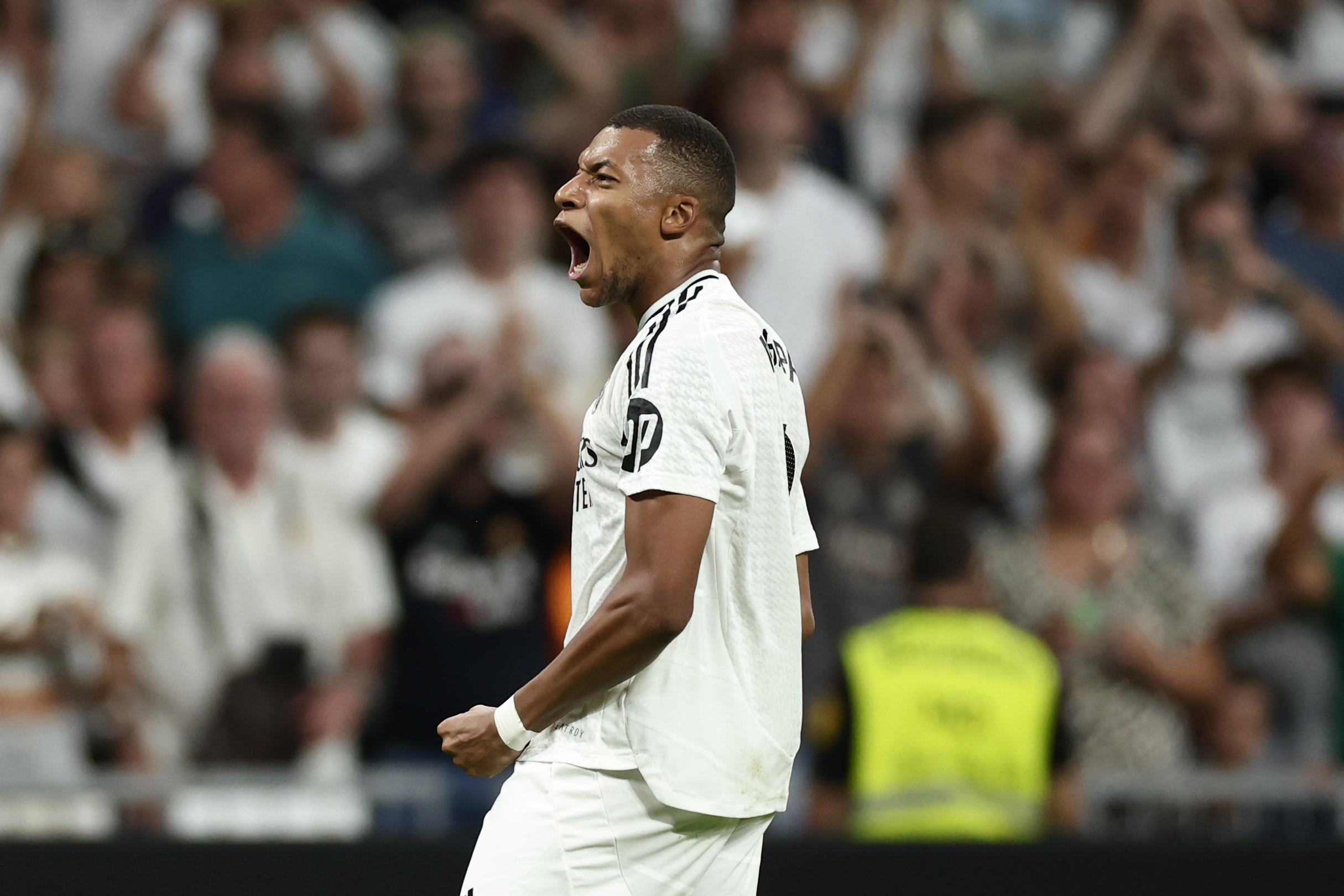 Real Madrid's Kylian Mbappe celebrates after scoring his sides second goal during the Spanish La Liga soccer match between Real Madrid and Betis at the Santiago Bernabeu stadium in Madrid, Spain, Sunday, Sept. 1, 2024.
