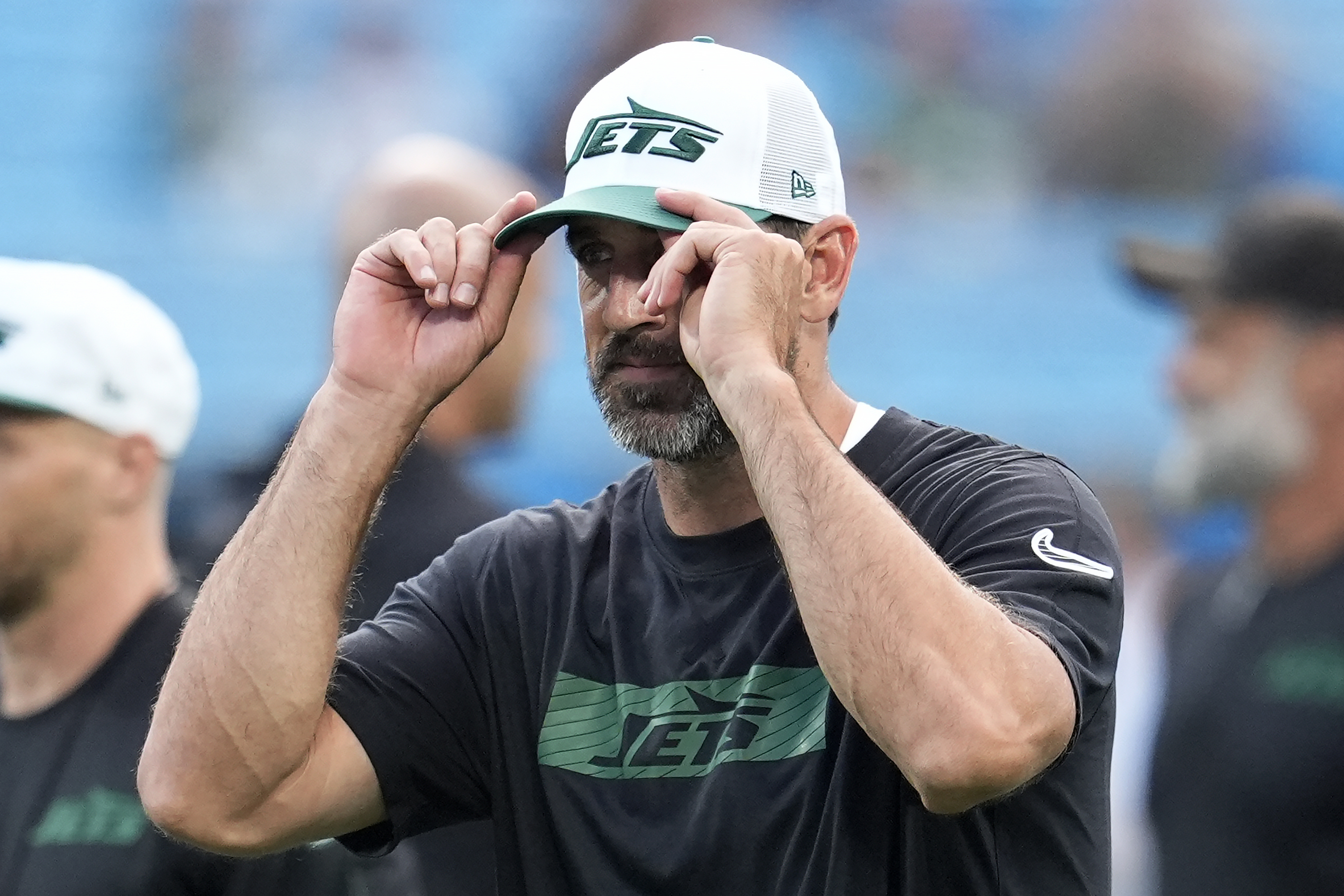 New York Jets quarterback Aaron Rodgers watches players warm up before a preseason NFL football game against the Carolina Panthers, Saturday, Aug. 17, 2024, in Charlotte, N.C.