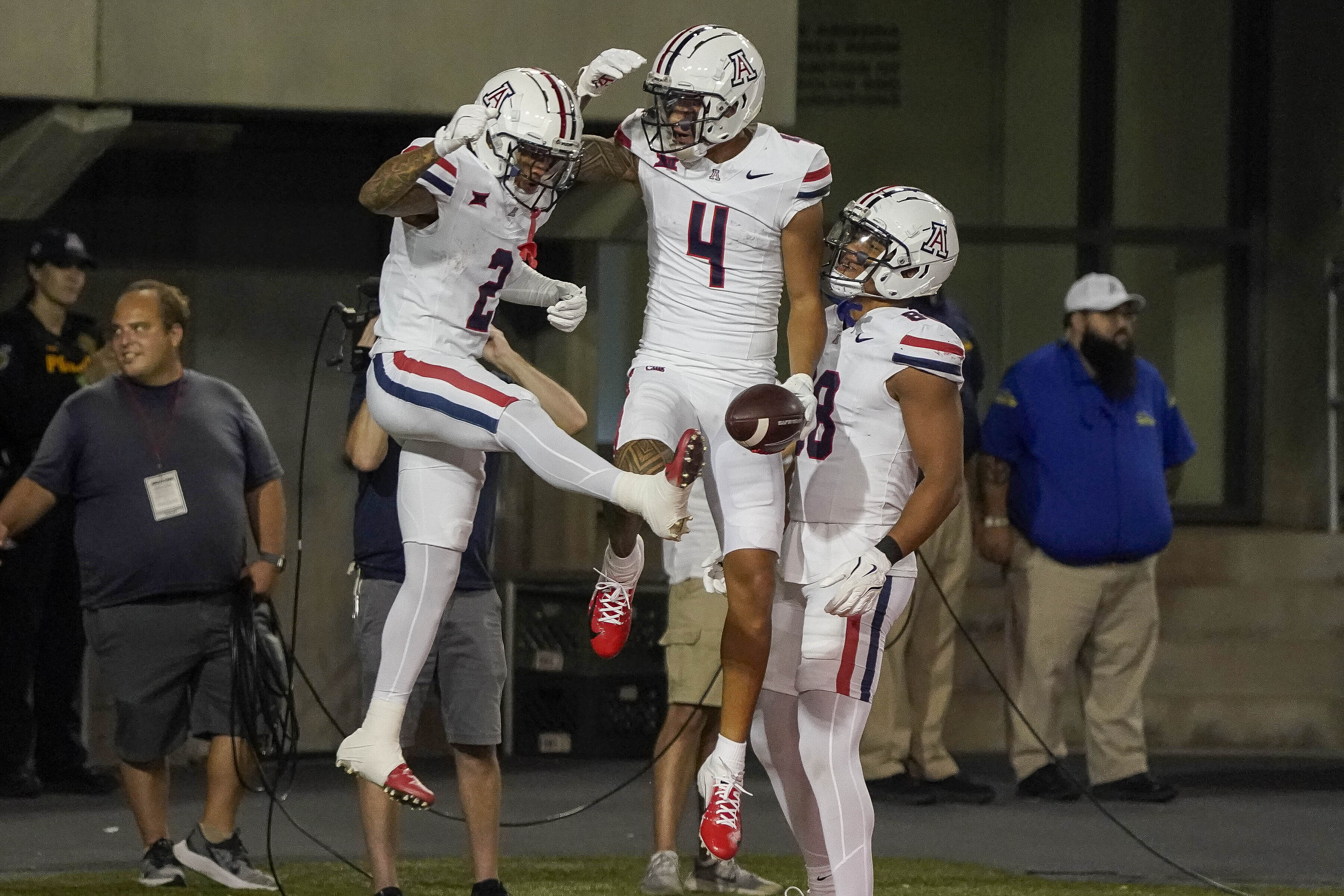 Arizona wide receiver Tetairoa McMillan (4) celebrates his touchdown against New Mexico with teammates Jeremiah Patterson (2) and Keyan Burnett, right, during the second half of an NCAA college football game Saturday, Aug. 31, 2024, in Tucson, Ariz. 