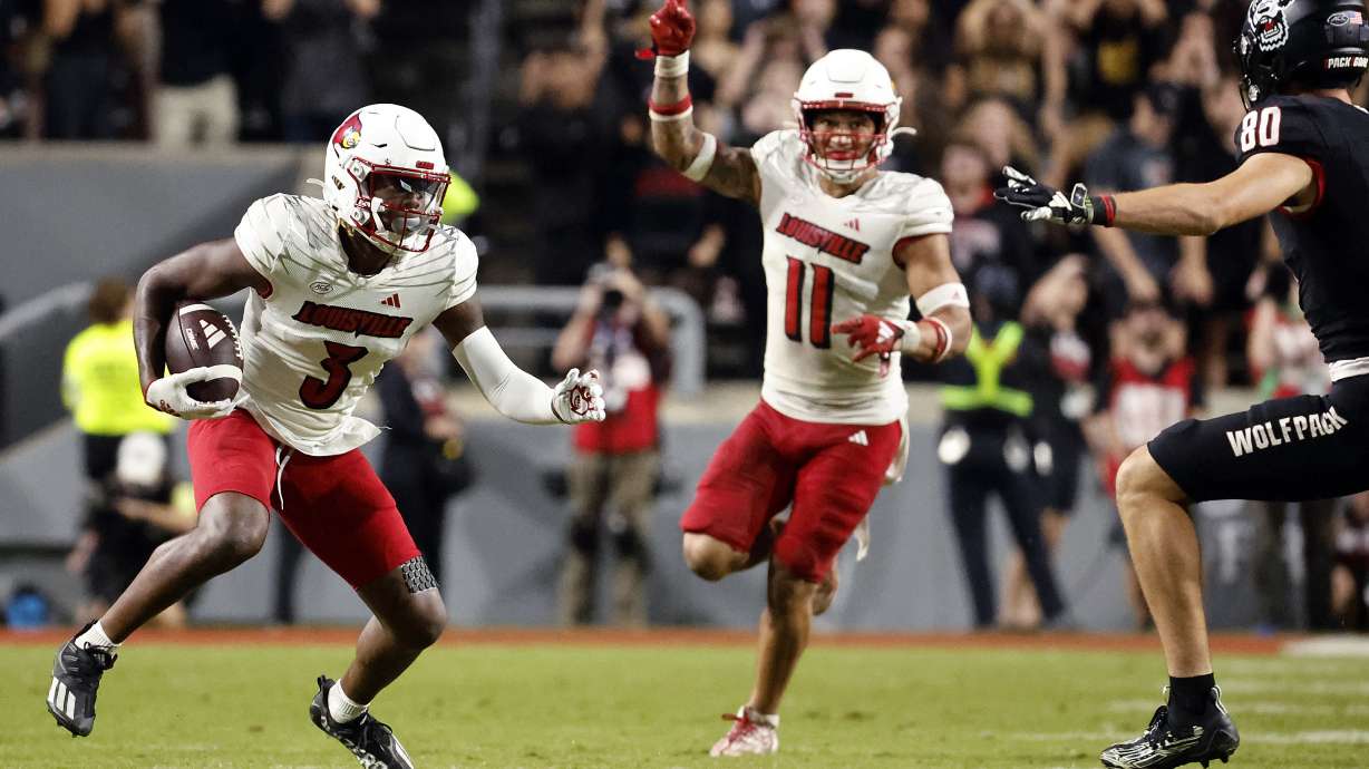 FILE - Louisville's Quincy Riley (3) runs with an interception as Cam'Ron Kelly (11) directs the return with North Carolina State's Bradley Rozner (80) defending during the second half of an NCAA college football game in Raleigh, N.C., Friday, Sept. 29, 2023.
