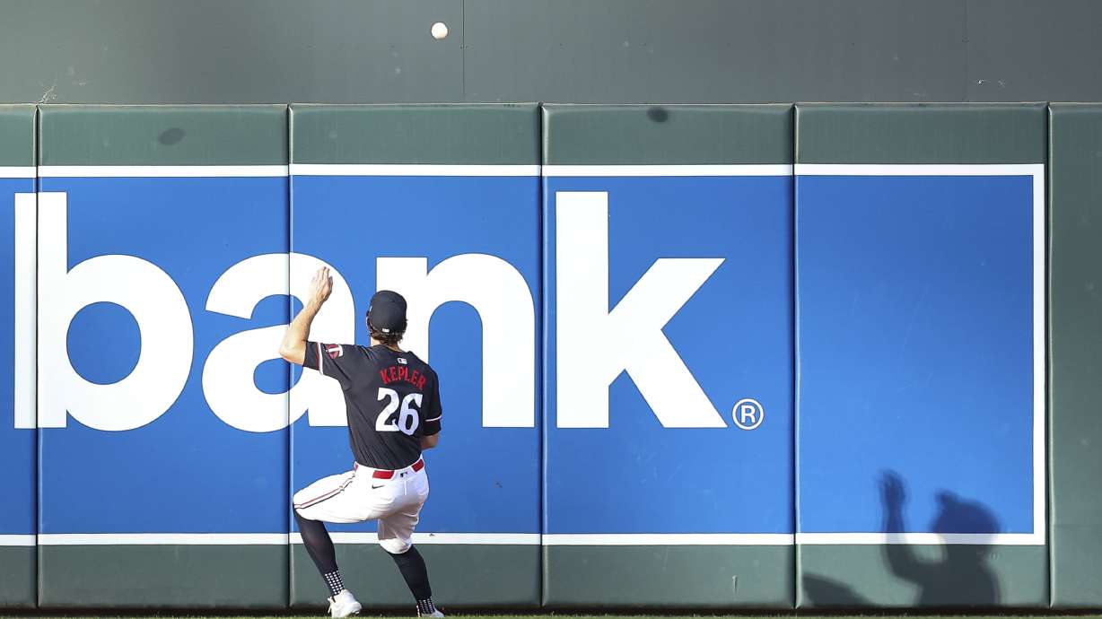 Minnesota Twins right fielder Max Kepler attempts to field the ball hit by Toronto Blue Jays' Alejandro Kirk during the first inning of a baseball game, Saturday, Aug. 31, 2024, in Minneapolis.