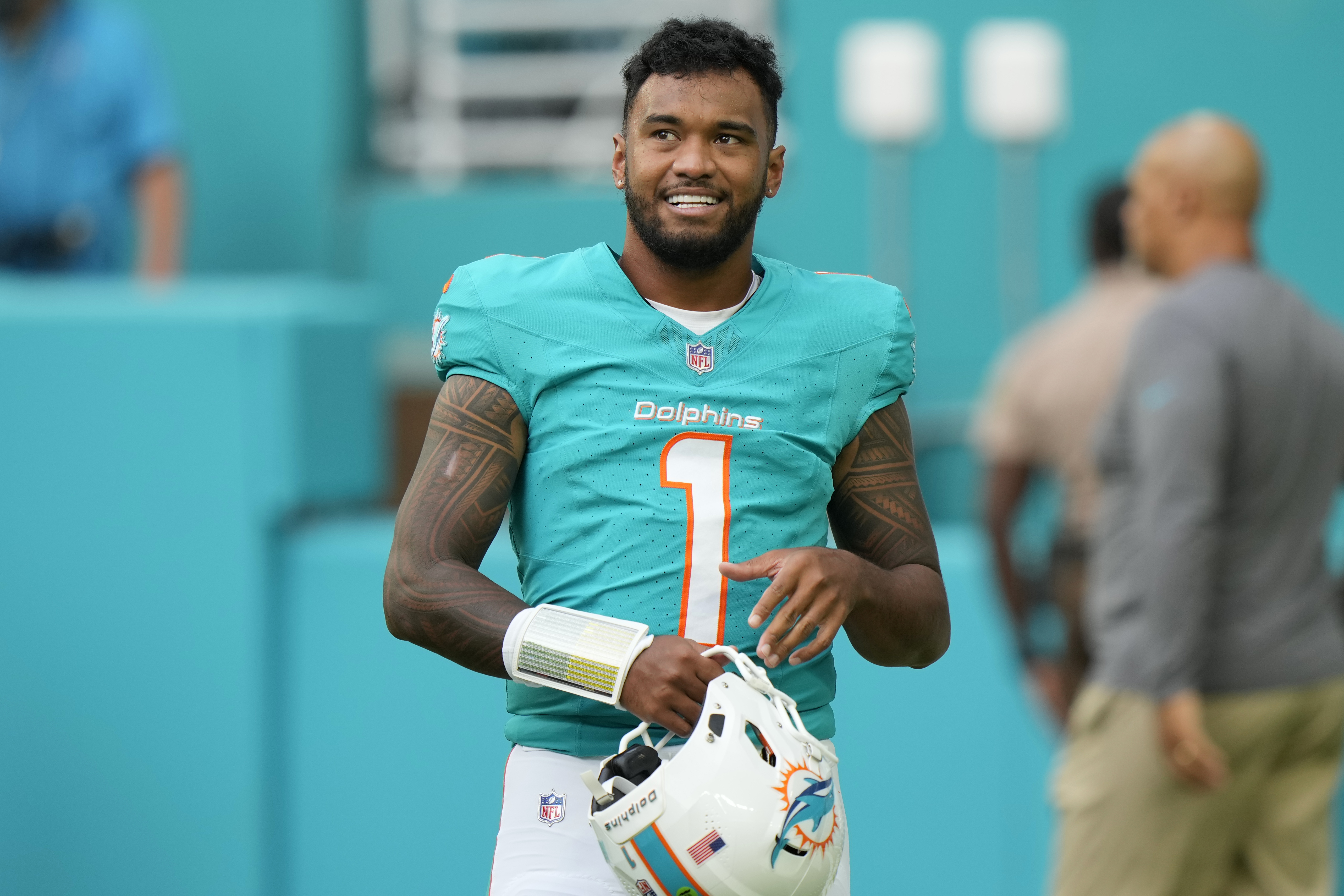 Miami Dolphins quarterback Tua Tagovailoa stands on the field before a preseason NFL football game against the Washington Commanders, Saturday, Aug. 17, 2024, in Miami Gardens, Fla. 