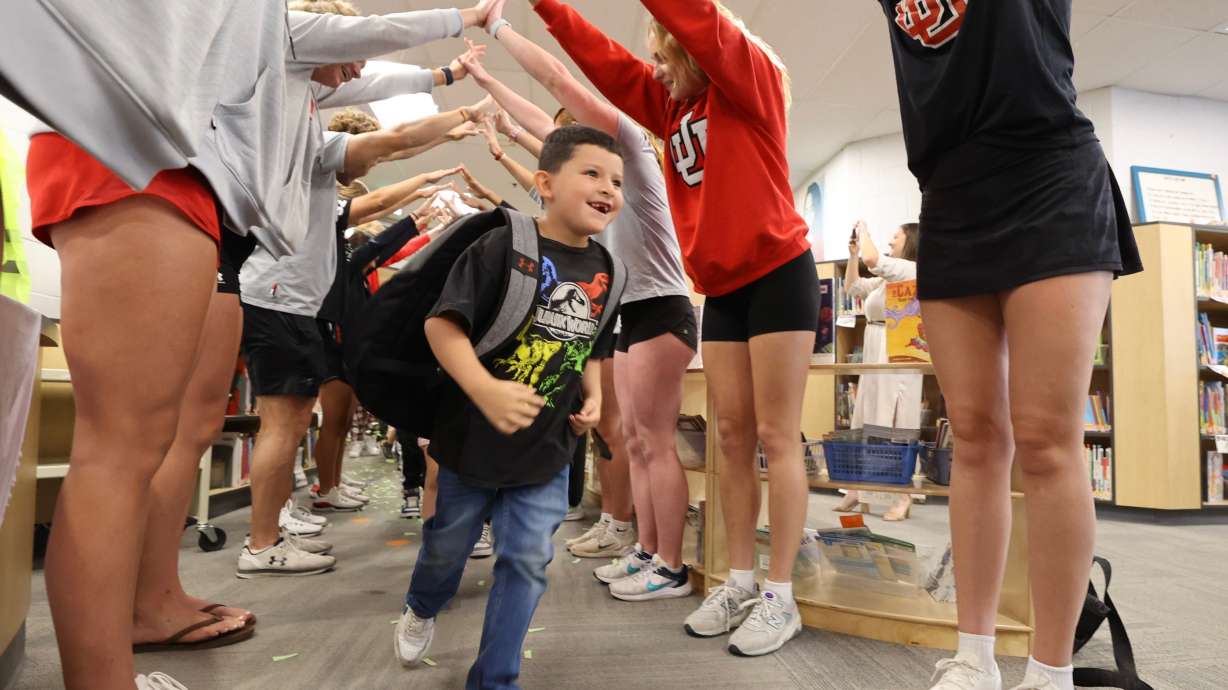Newman Elementary School second grader Santana Chavez runs into the new school library Thursday. Newman Elementary School on Thursday morning welcomed students to a new and improved, renovated library.