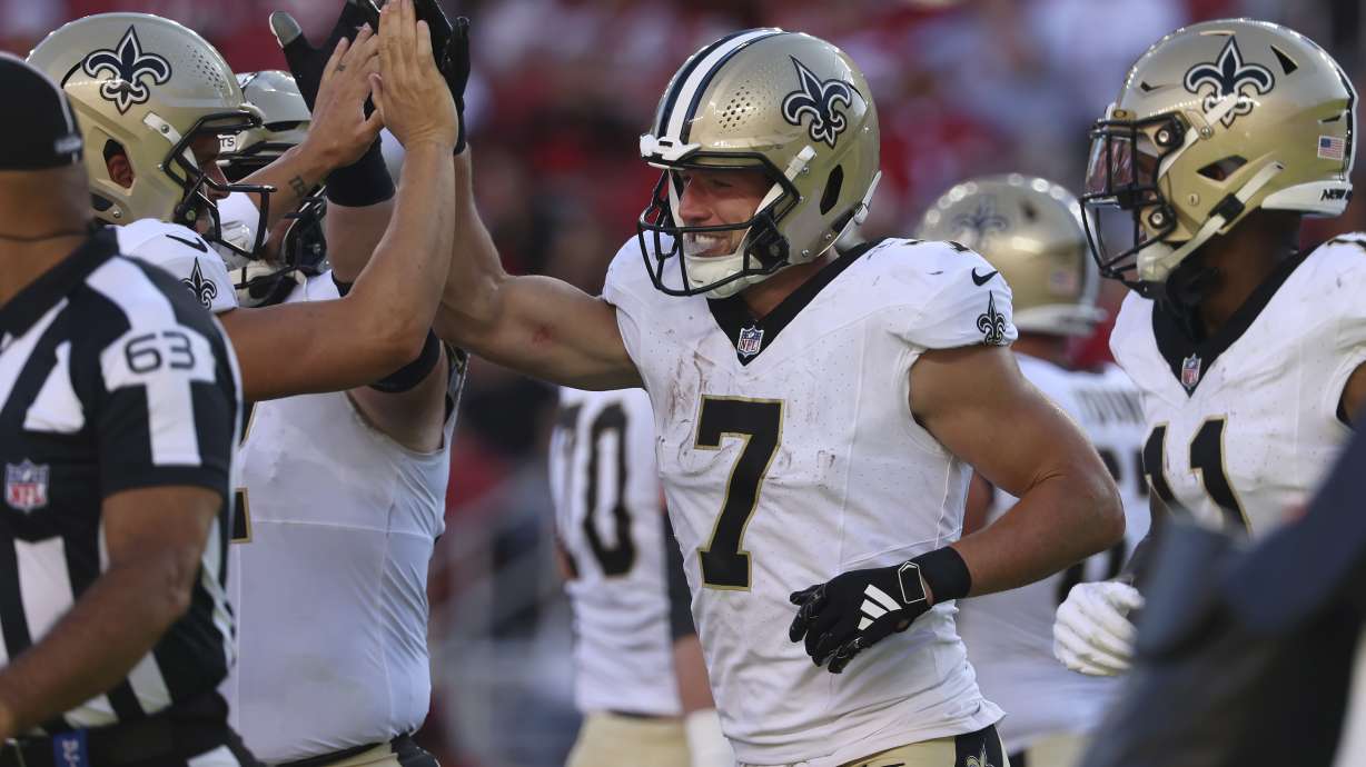 New Orleans Saints' Taysom Hill (7) is congratulated by teammates after scoring against the San Francisco 49ers during the first half of a preseason NFL football game in Santa Clara, Calif., Sunday, Aug. 18, 2024.