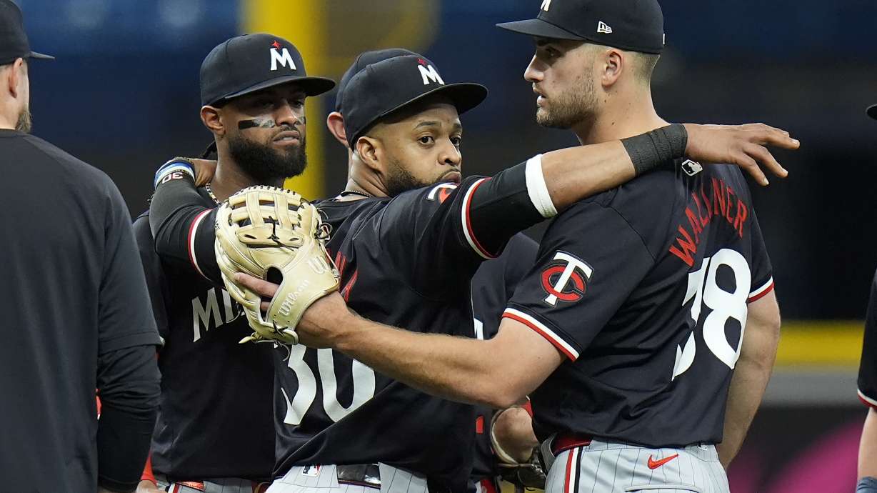 Minnesota Twins left fielder Matt Wallner (38) celebrates with first baseman Carlos Santana (30) and second baseman Willi Castro after the team defeated the Tampa Bay Rays during a baseball game Thursday, Sept. 5, 2024, in St. Petersburg, Fla.