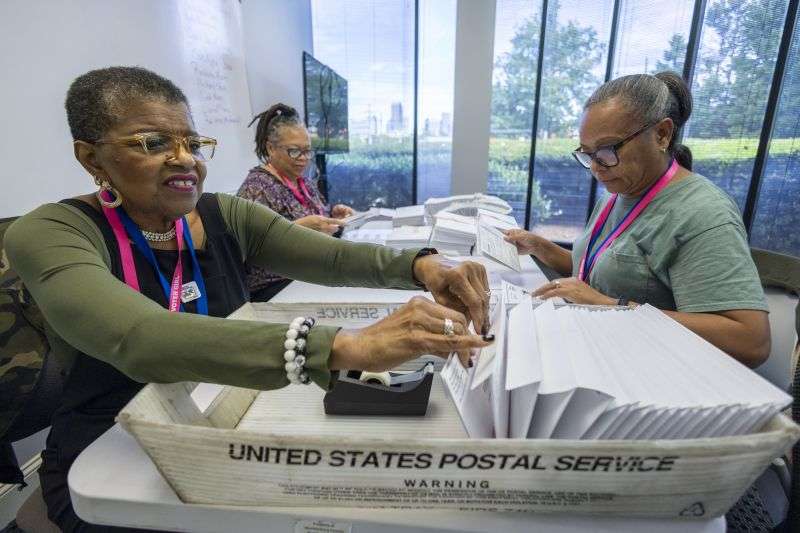From left: Carol Hamilton, Cristo Carter and Cynthia Huntley prepare ballots to be mailed at the Mecklenburg County Board of Elections in Charlotte, N.C., Thursday.