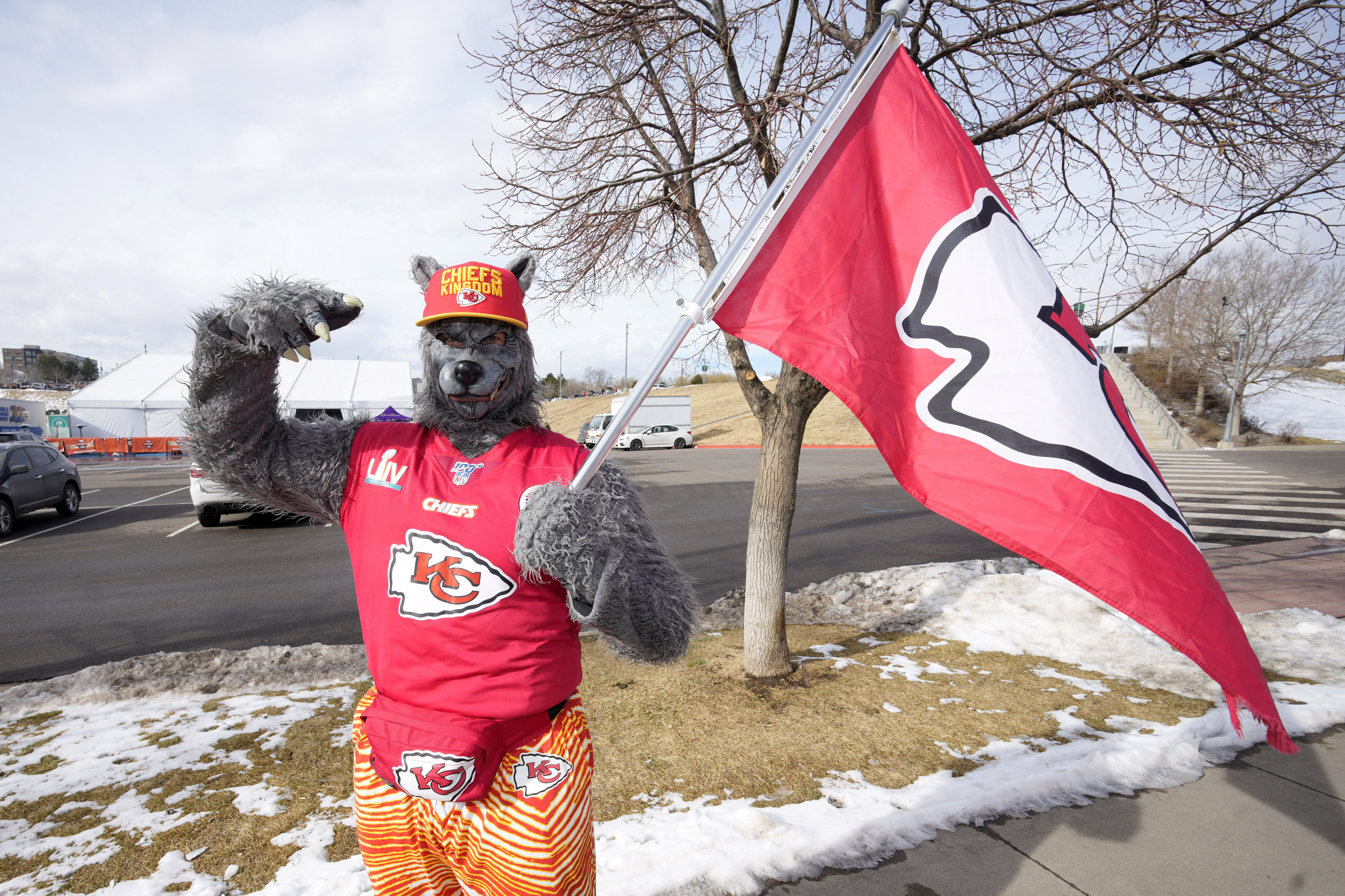 FILE - A Kansas City Chiefs fan, Chiefsaholic, poses for photos while walking toward Empower Field at Mile High before an NFL football game between the Denver Broncos and the Chiefs, Jan. 8, 2022, in Denver. 