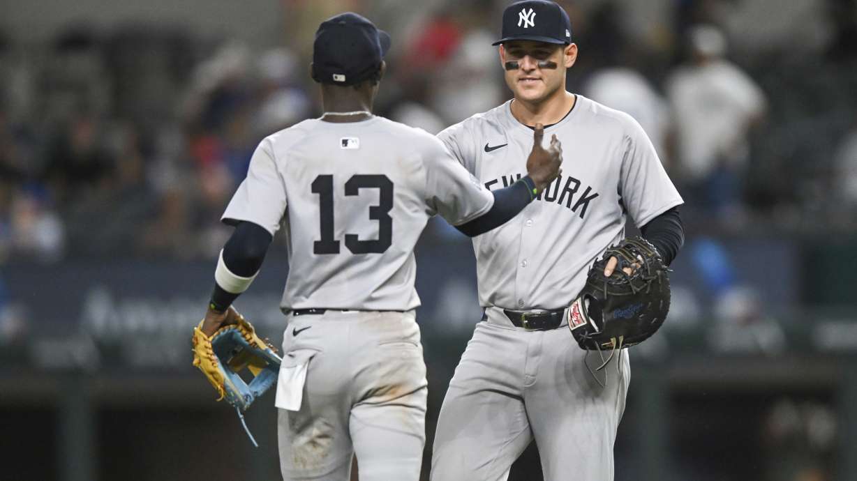 New York Yankees Anthony Rizzo, right, and teammate Jazz Chisholm Jr., left, celebrate after a baseball game against the Texas Rangers, Monday, Sept. 2, 2024, in Arlington, Texas.