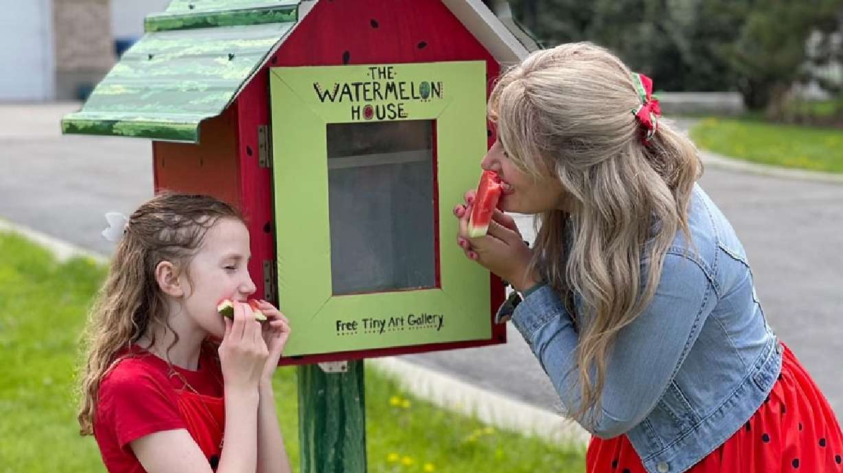 From left, Bria and Kaatia Larsen stand at The Watermelon House in Rexburg, Idaho in this undated image. They hope the free tiny art gallery they created will help keep the community connected.