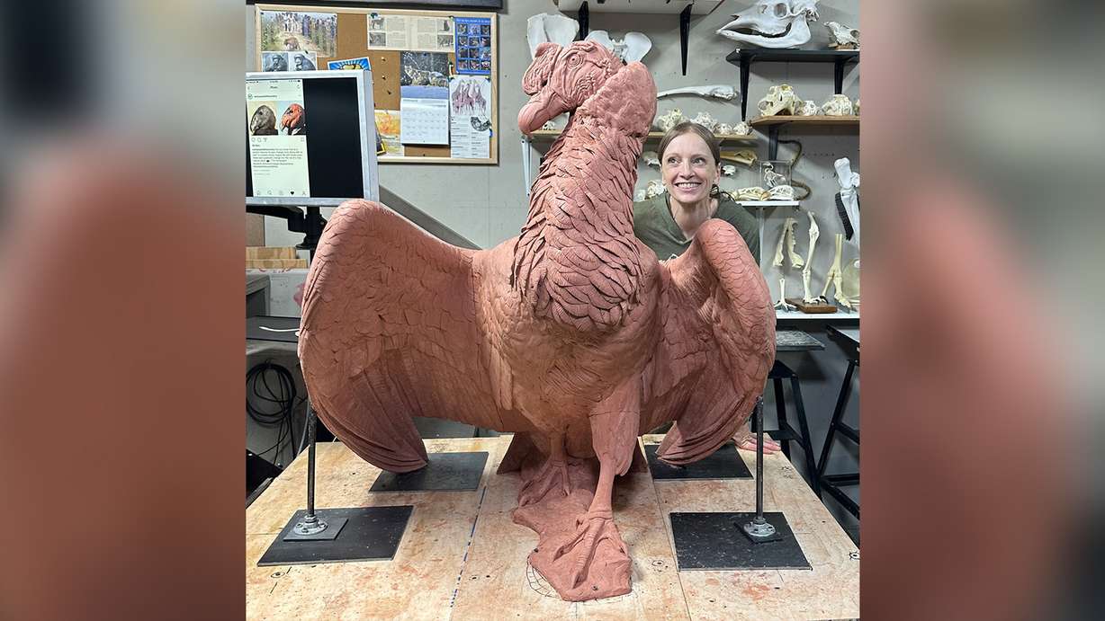Helen Dishaw, curator of bird programs for Tracy Aviary, and Andy N. Condor's long-time caretaker, poses for a photo with a clay model of Andy in April. The model was selected for the bronze statue immortalizing the Andean condor that was a fixture at the Salt Lake City aviary for 63 years.