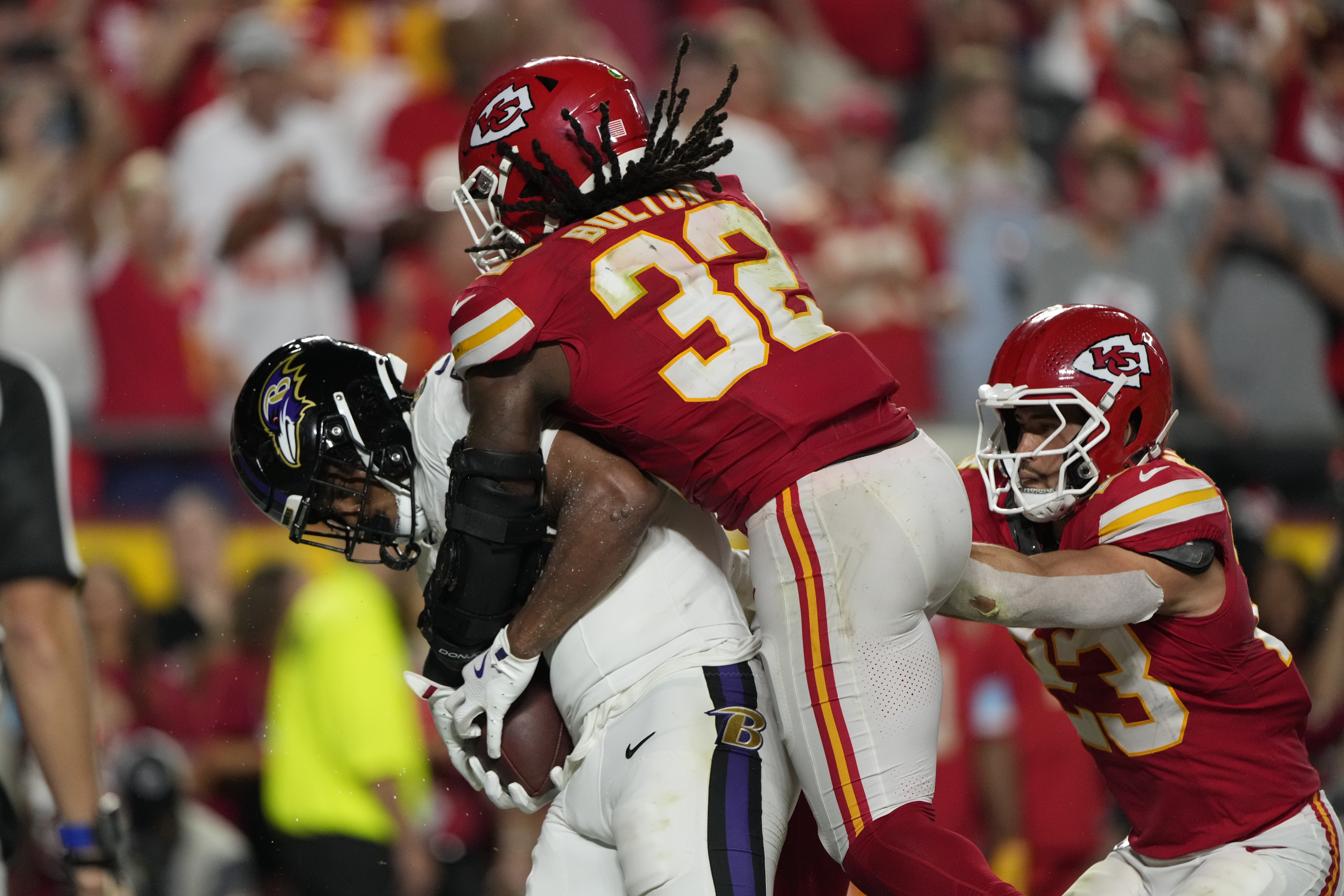 Baltimore Ravens tight end Isaiah Likely, left, catches a pass out of bounds as Kansas City Chiefs linebacker Nick Bolton (32) and linebacker Drue Tranquill (23) defend as time time expires in the second half of an NFL football game Thursday, Sept. 5, 2024, in Kansas City, Mo. The Chiefs won 27-20. 