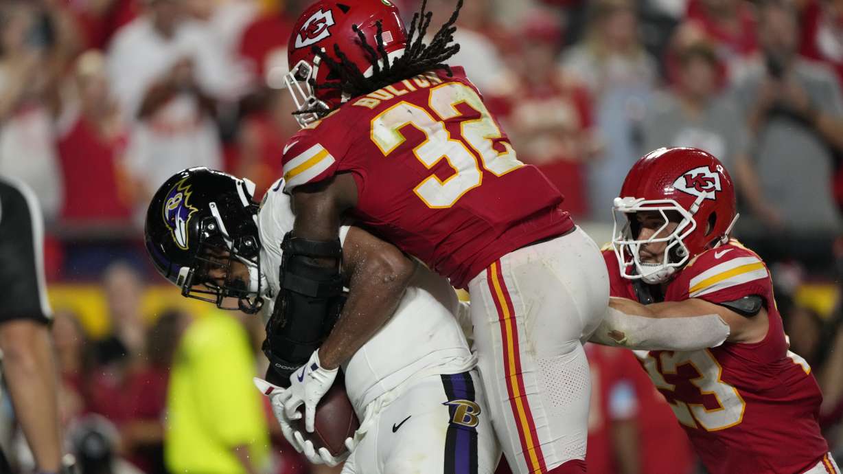 Baltimore Ravens tight end Isaiah Likely, left, catches a pass out of bounds as Kansas City Chiefs linebacker Nick Bolton (32) and linebacker Drue Tranquill (23) defend as time time expires in the second half of an NFL football game Thursday, Sept. 5, 2024, in Kansas City, Mo. The Chiefs won 27-20.