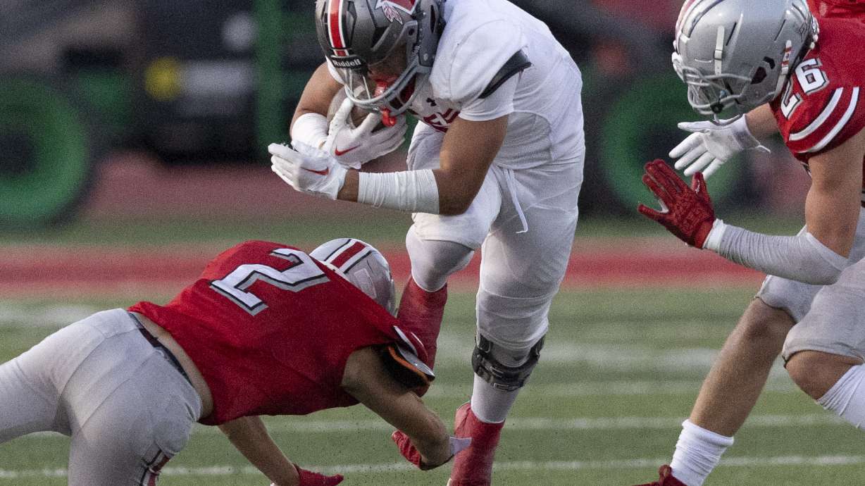 Uintah’s Kaysten Ussery (5) jumps out of a tackle by Spanish Fork’s Gage Christensen (2) at Spanish Fork High School in Spanish Fork on Thursday, Sept. 5, 2024.