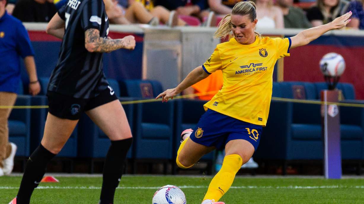 Amandine Henry, right, kicks the ball at America First Field.