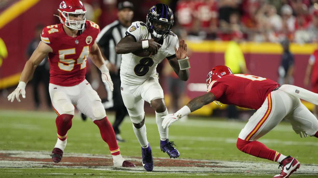 Baltimore Ravens quarterback Lamar Jackson (8) runs with the ball as Kansas City Chiefs safety Bryan Cook, right, and linebacker Leo Chenal (54) defend during the second half of an NFL football game Thursday, Sept. 5, 2024, in Kansas City, Mo.
