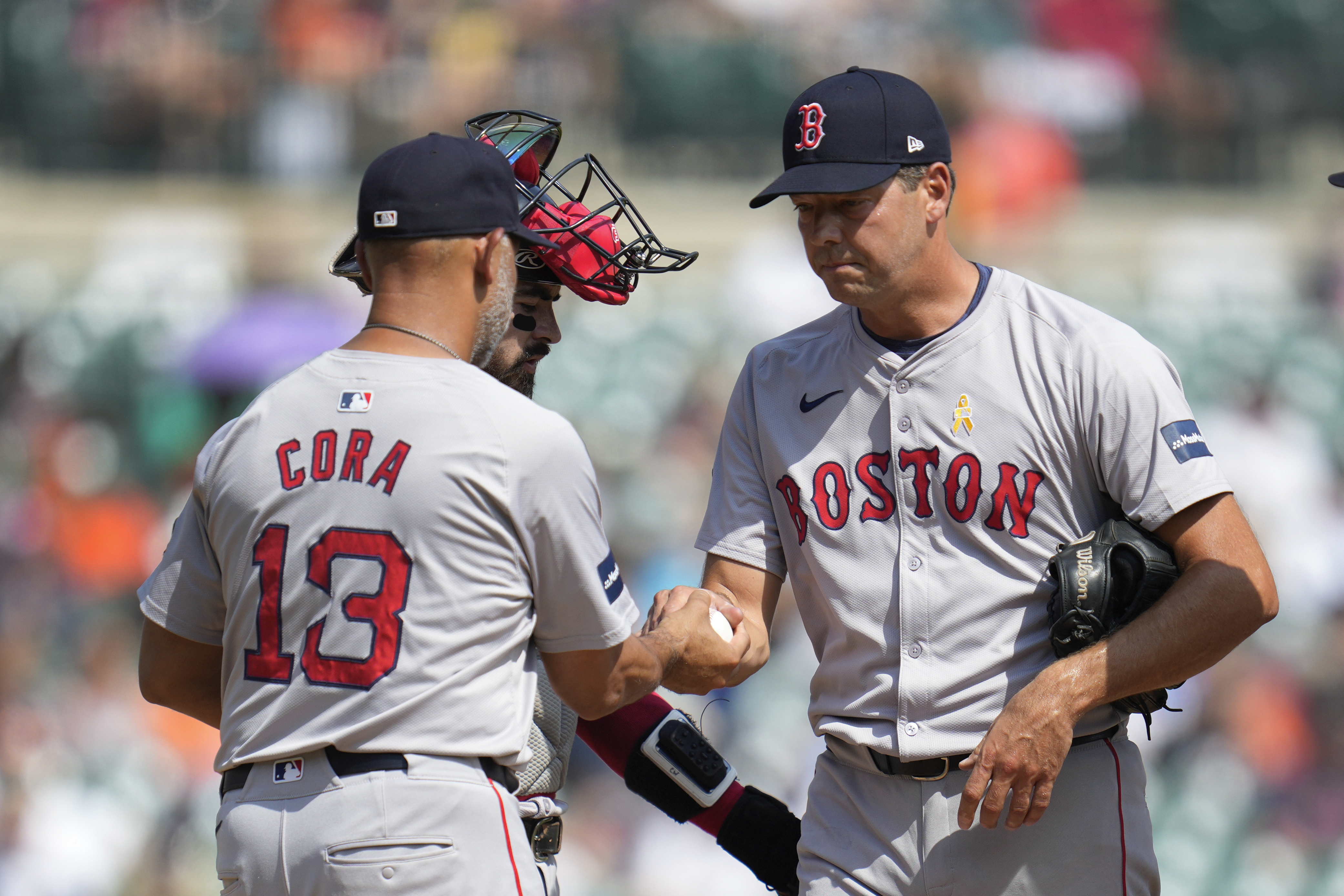 Boston Red Sox manager Alex Cora (13) takes the ball from pitcher Rich Hill against the Detroit Tigers in the fifth inning of a baseball game, Sunday, Sept. 1, 2024, in Detroit. 