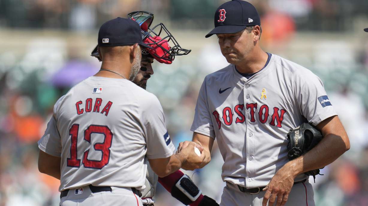 Boston Red Sox manager Alex Cora (13) takes the ball from pitcher Rich Hill against the Detroit Tigers in the fifth inning of a baseball game, Sunday, Sept. 1, 2024, in Detroit.